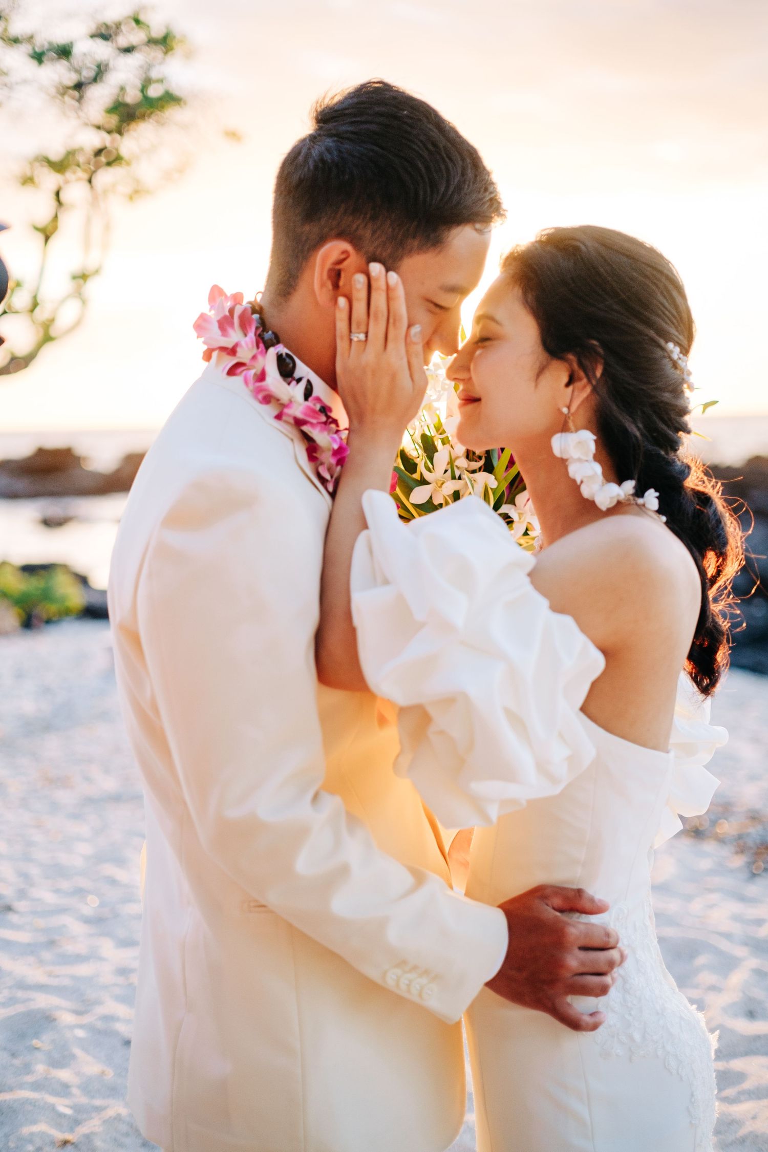 Romantic beach photography session with flowing white outfits at sunset at Kikaua Point Beach, Big Island of Hawaii.