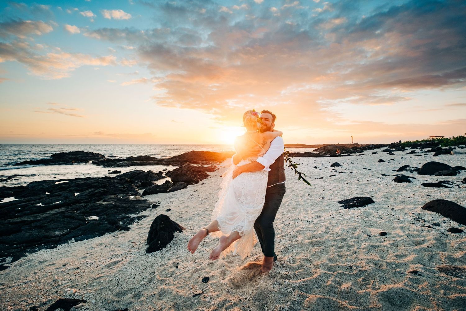 Romantic beach sunset photoshoot with silhouettes against colorful sky and ocean waves at Kona Salt Farm, Big Island Hawaii.
