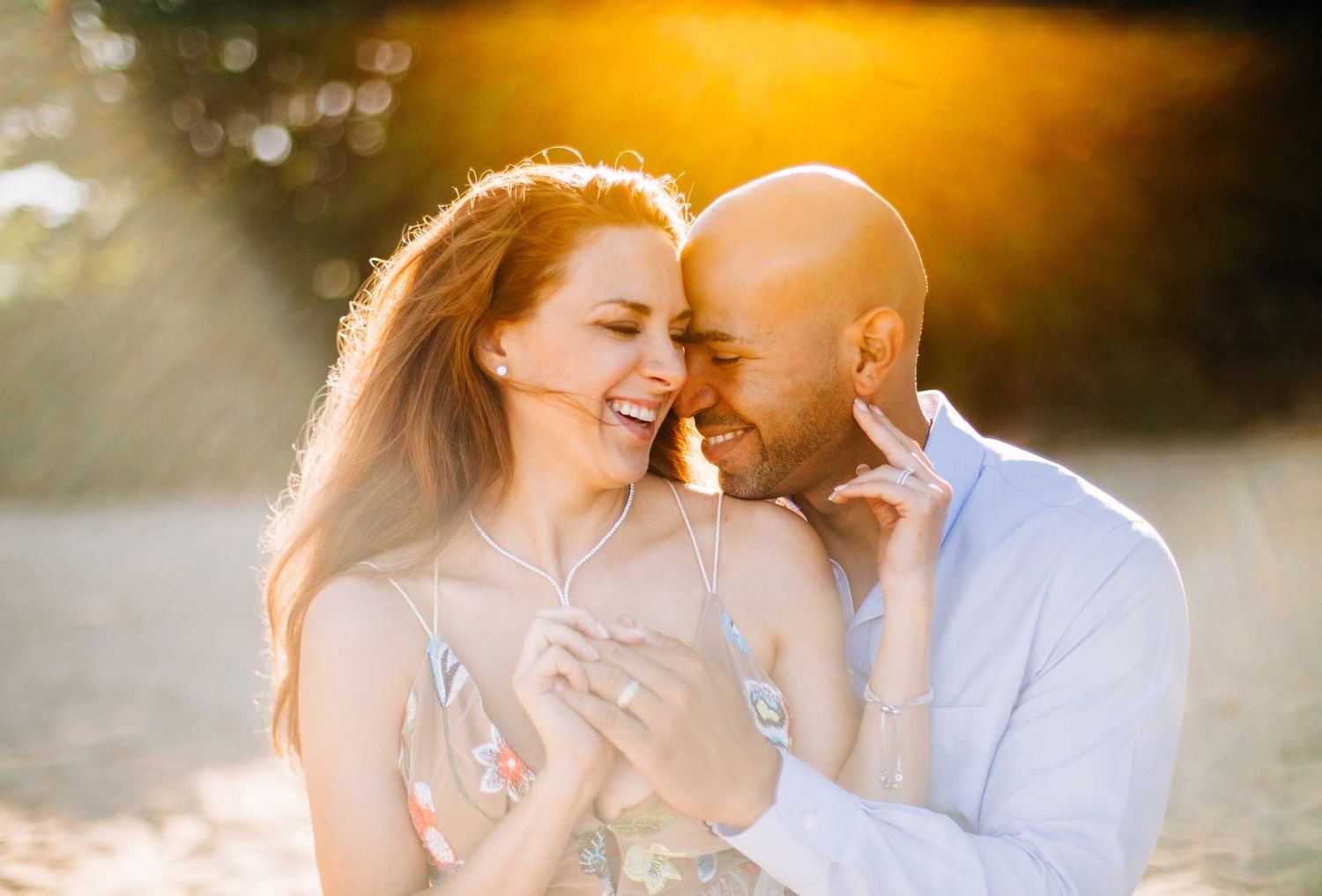 Couple sharing an intimate moment in golden sunset light on the Big Island of Hawaii.