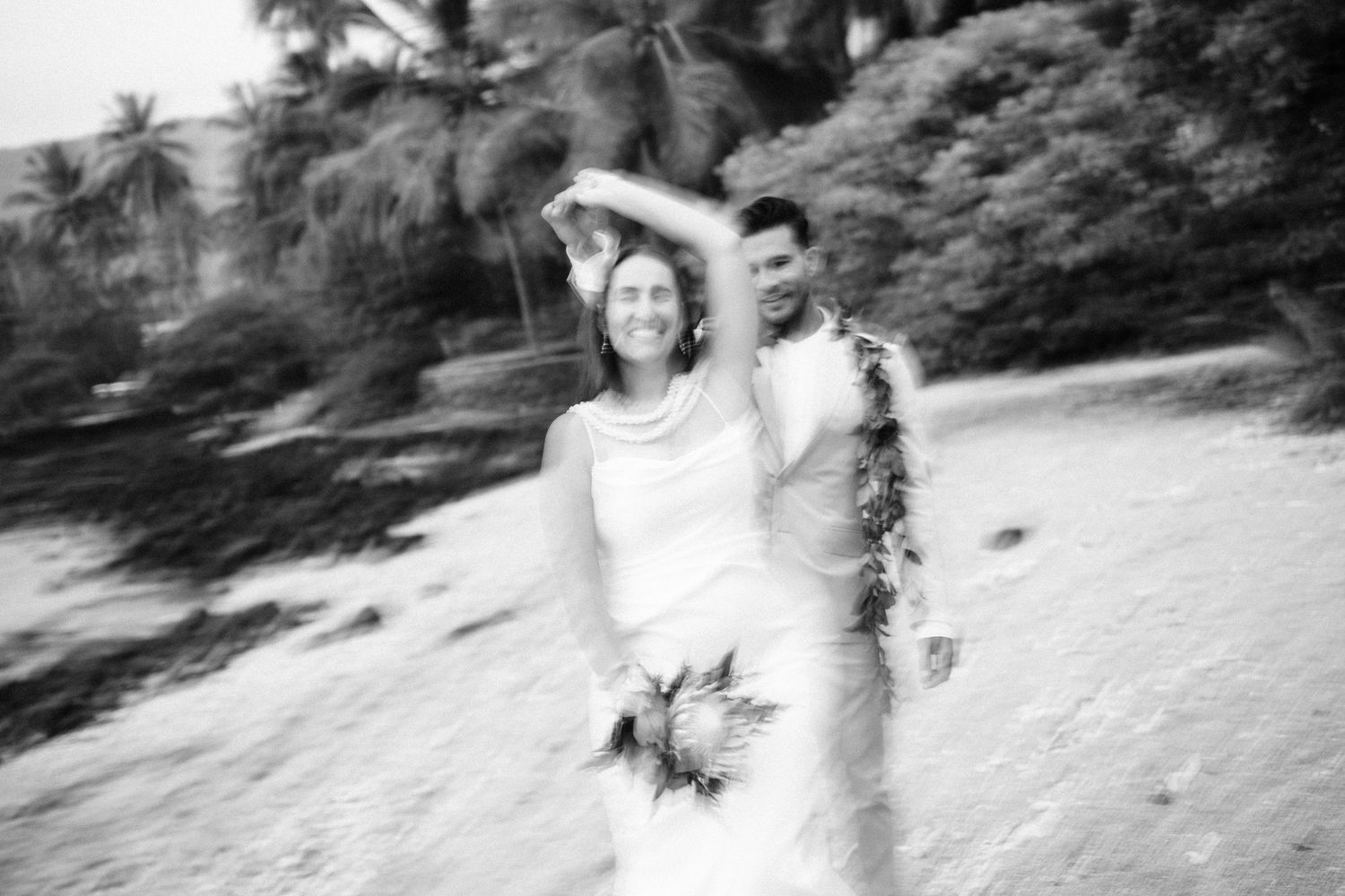 Black and white motion blur photography of people on tropical beach in Kona, Big Island of Hawaii.