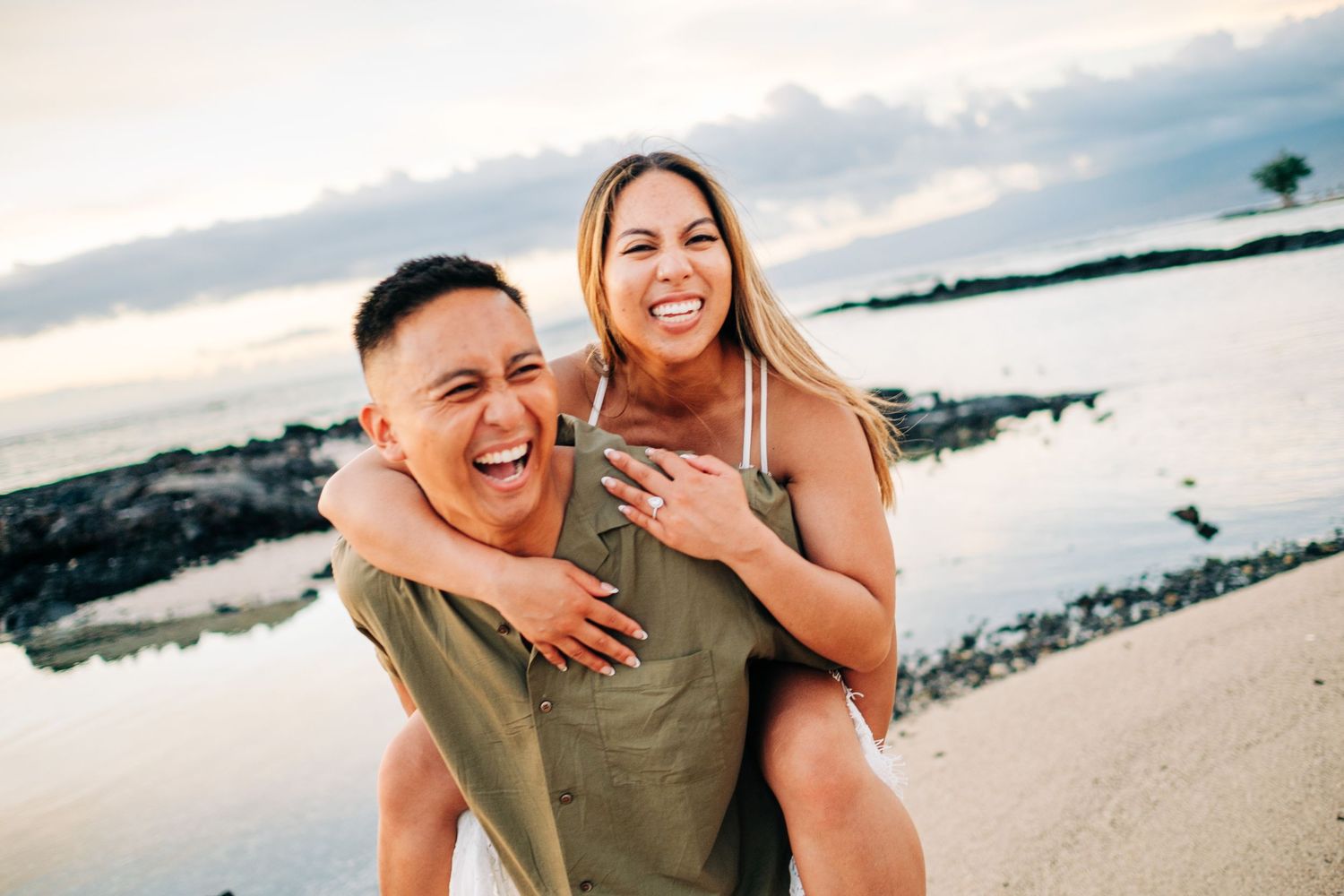 Playful beach photoshoot during golden hour with ocean waves in background at Mauna Lani, Big Island Hawaii.