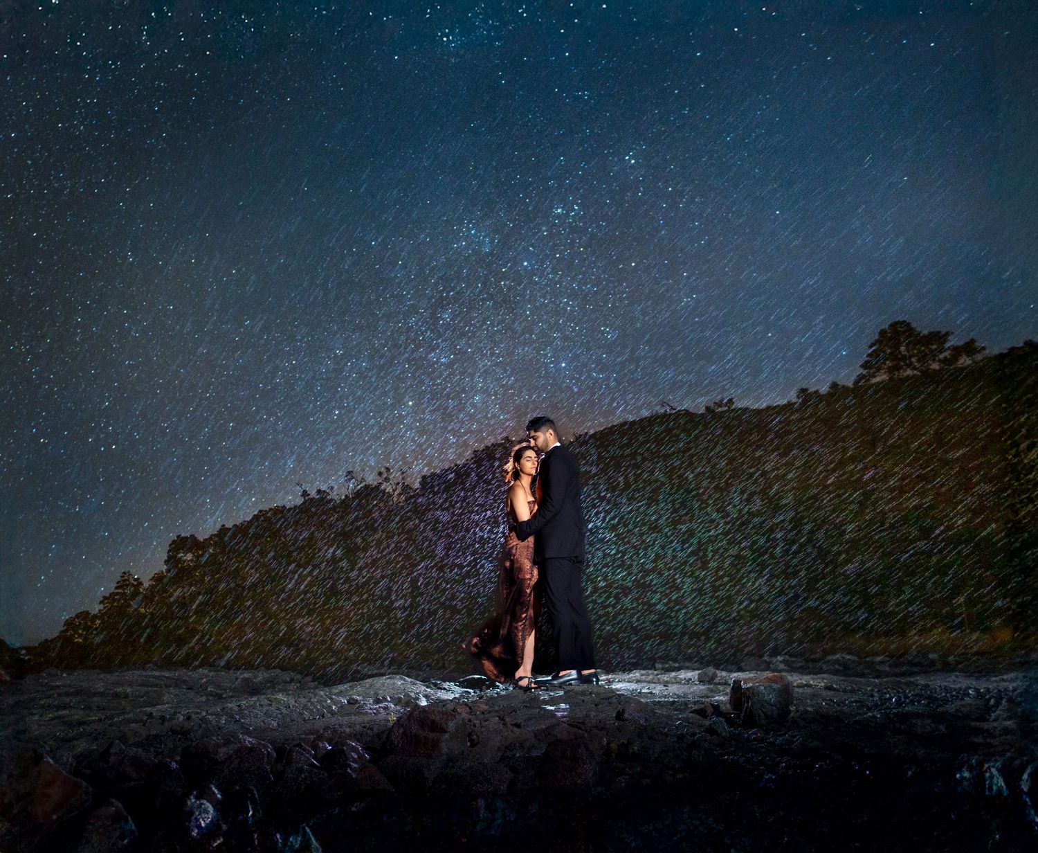 Starlit night photography session against a dramatic mountain landscape on the Big Island of Hawaii.