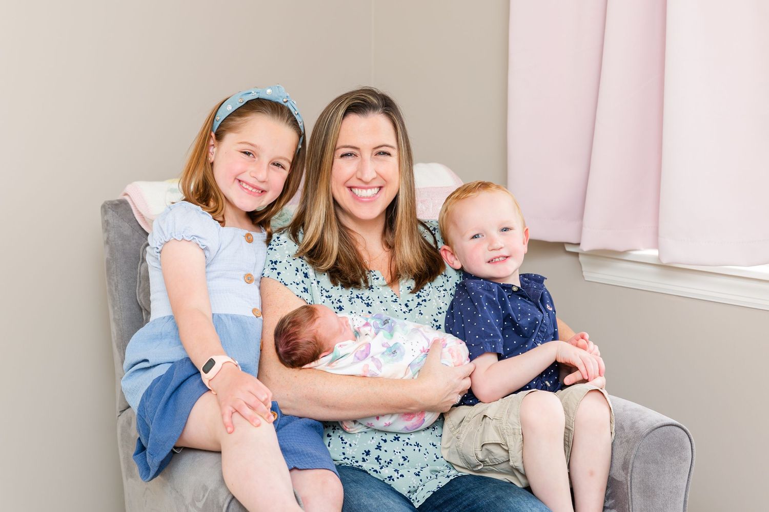 Indoor family gathering with babies and adults on couch.