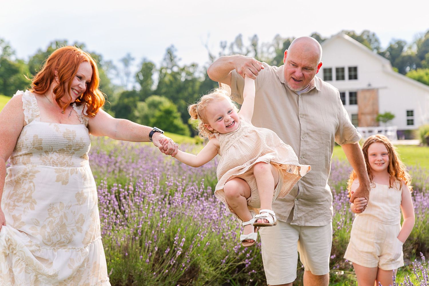 Family enjoying time together in blooming lavender field.