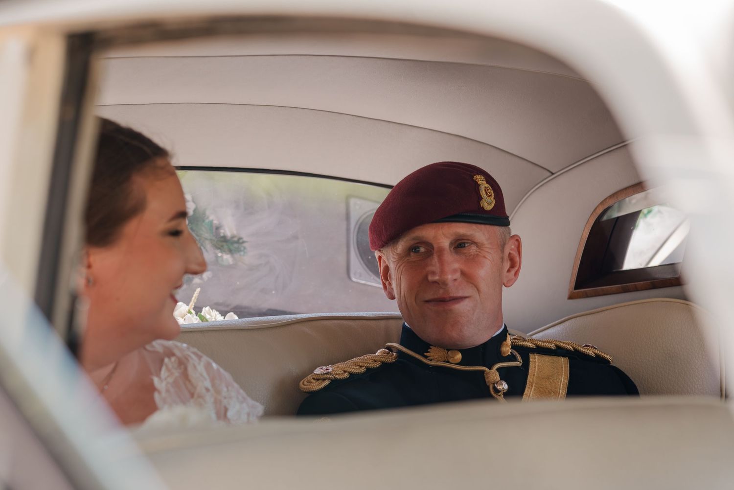 Newlywed royal couple shares a public kiss while seated in a vintage carriage at their wedding ceremony.