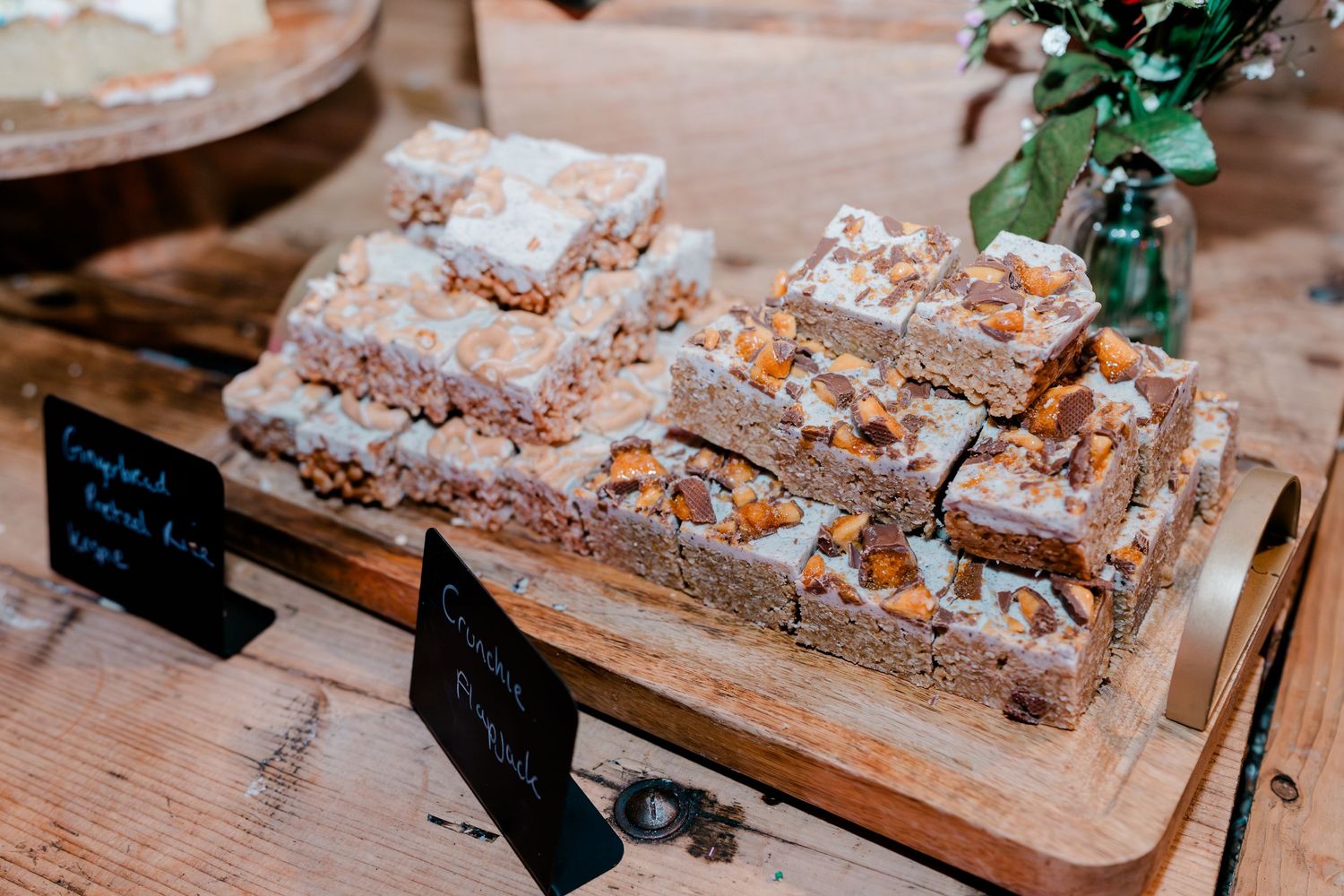 Rustic wedding dessert table featuring caramel topped traybake slices.