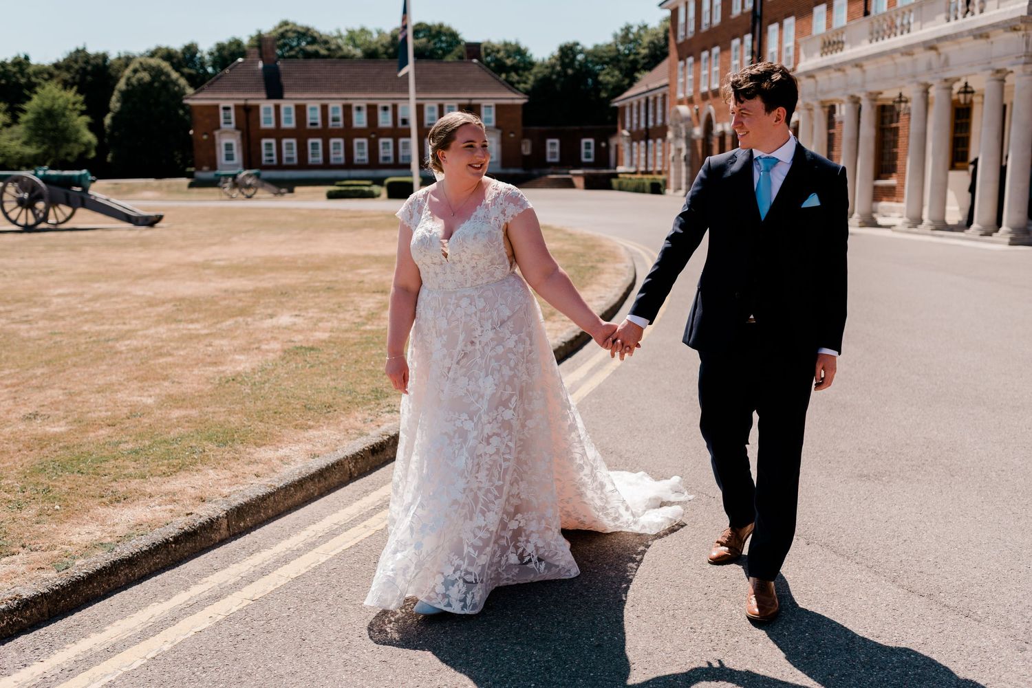Newlyweds stroll along a scenic outdoor path on their wedding day.
