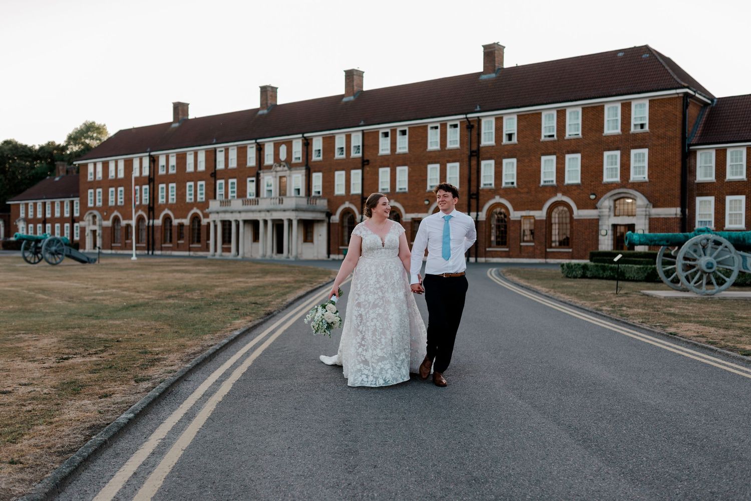 Brick buildings stand against a sunset sky at Fort Monroe, creating a historic architectural backdrop.