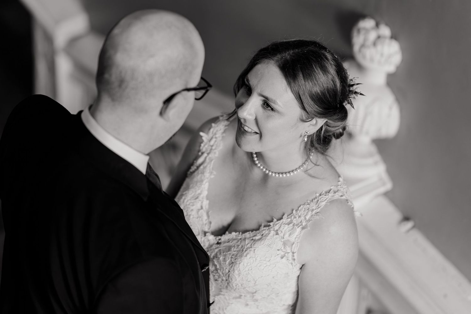 Romantic black and white portrait of a couple in intimate embrace during their wedding day.