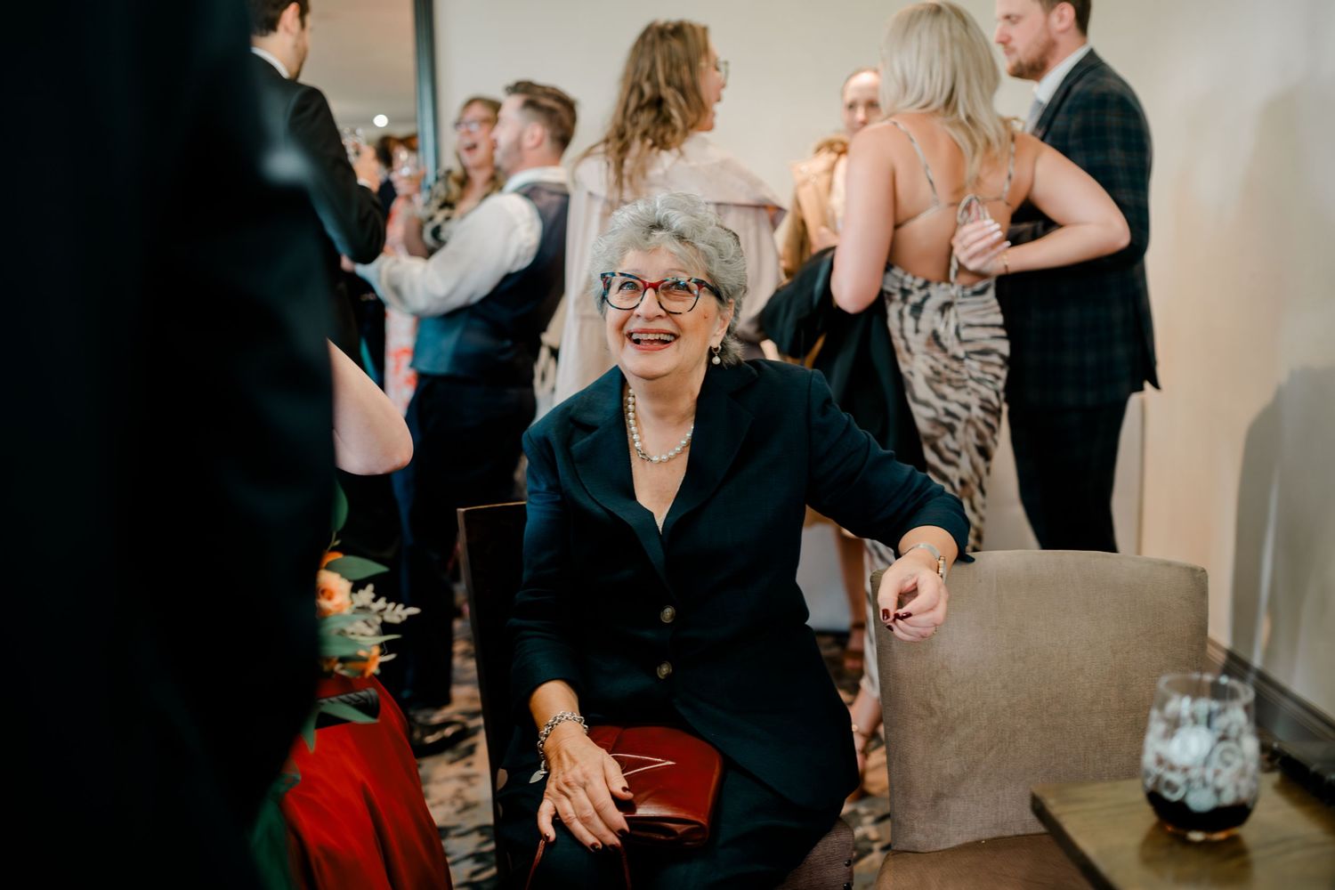 Wedding celebration candid moments captured with guests gathered in a bright indoor venue.