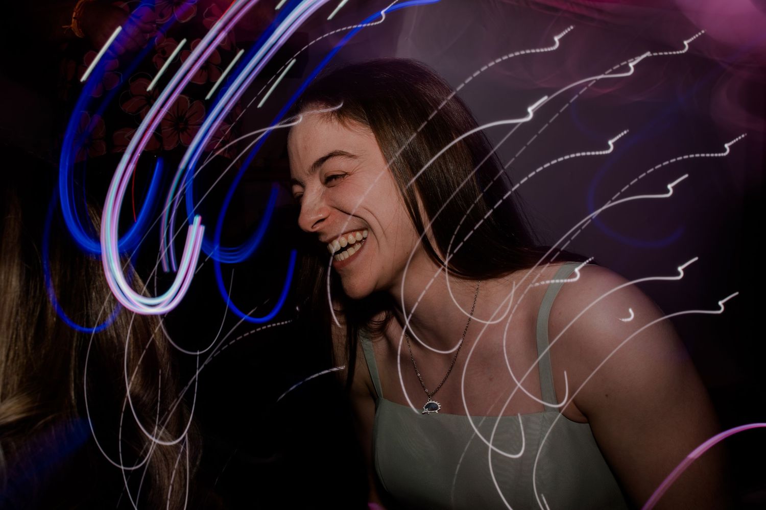Creative light painting photography with blue neon streaks in dark setting.