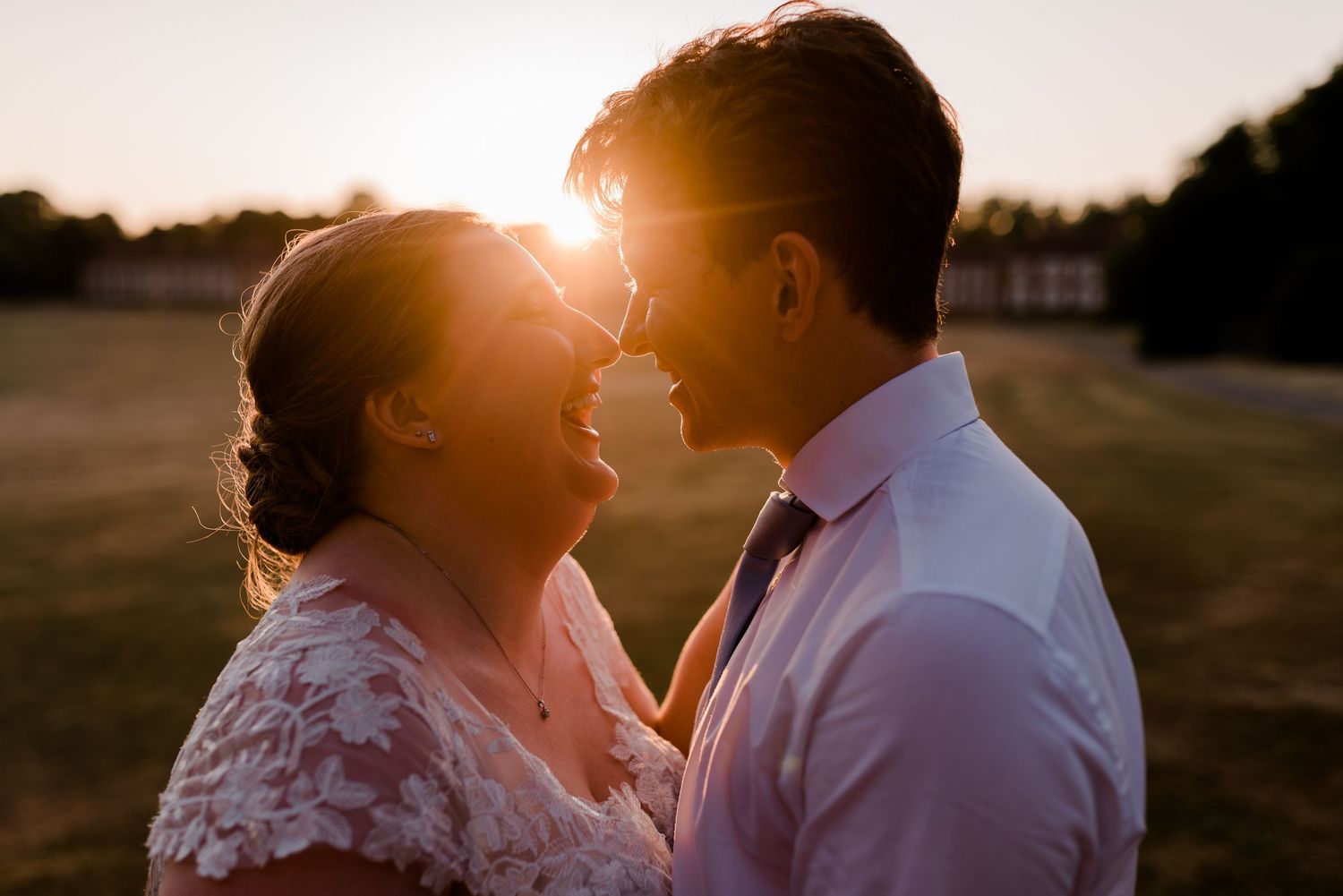 A couple shares an intimate moment during golden hour photography session at a historic fort.