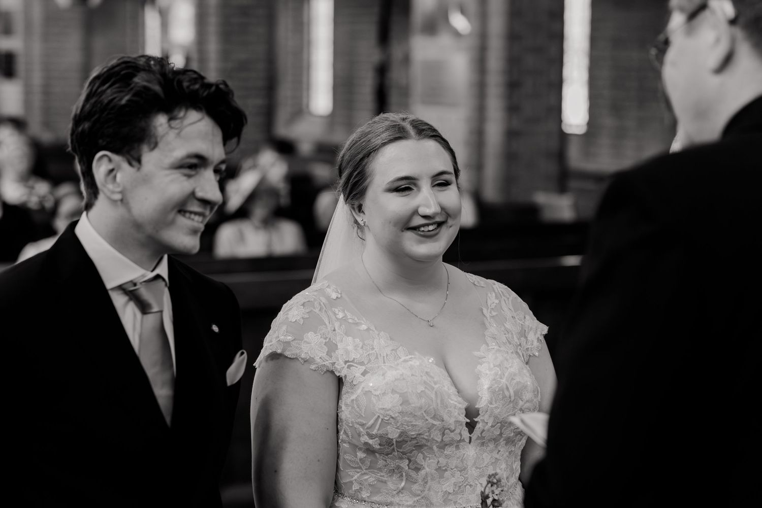 A black and white photo montage showing candid moments of a bride and groom laughing together during their wedding.