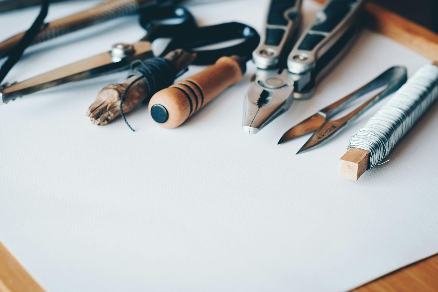 Vintage calligraphy fountain pens and writing tools laid out on white paper for artistic handwriting and lettering.