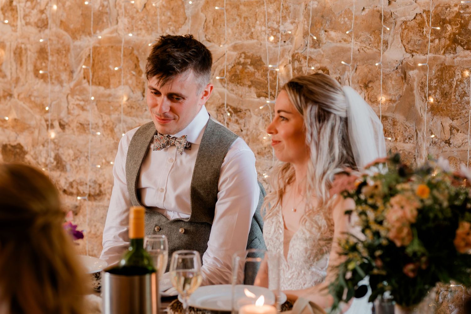 Wedding party celebration in a rustic venue with exposed brick walls and warm lighting.
