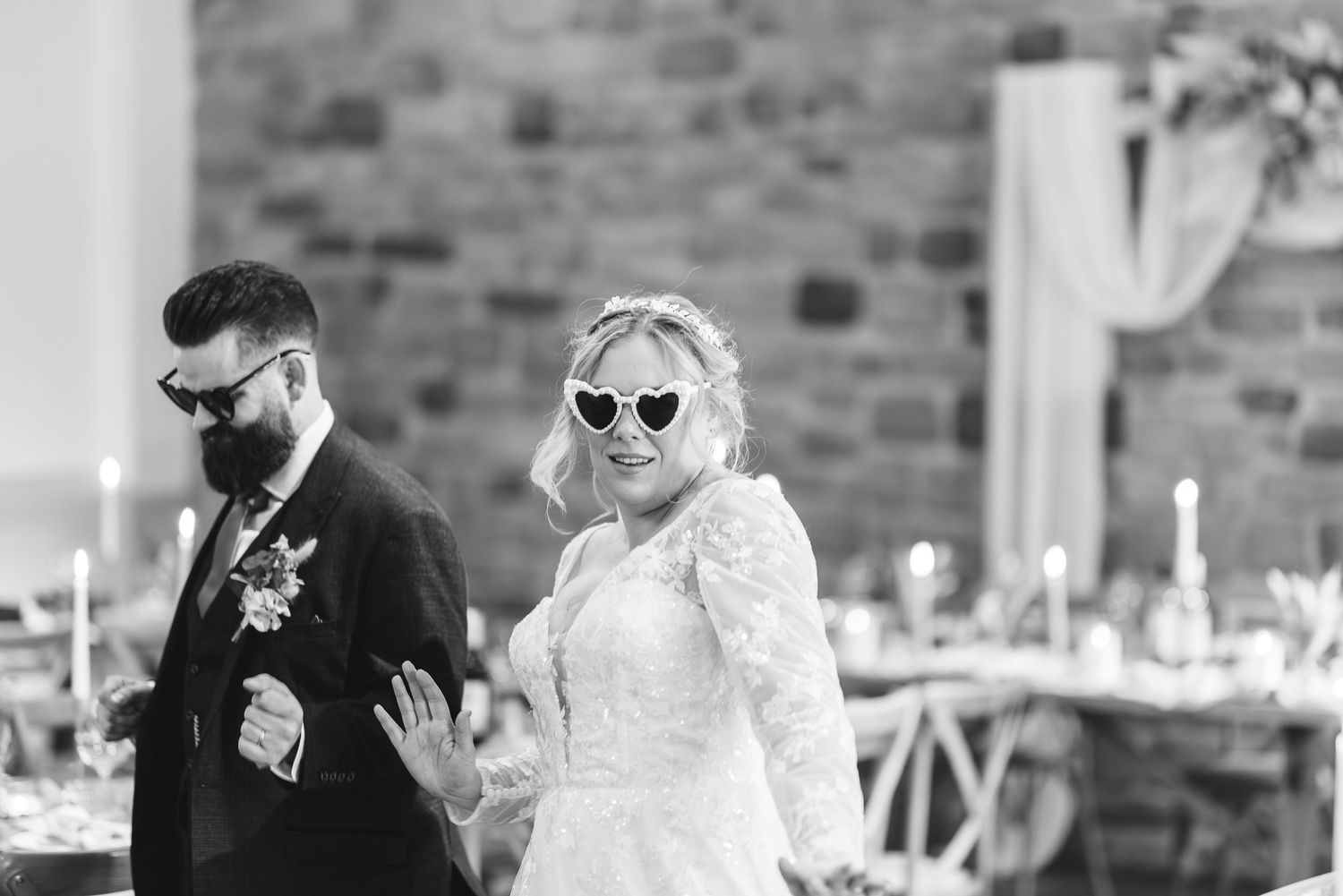 Black and white photo of stylish couple at wedding reception venue.