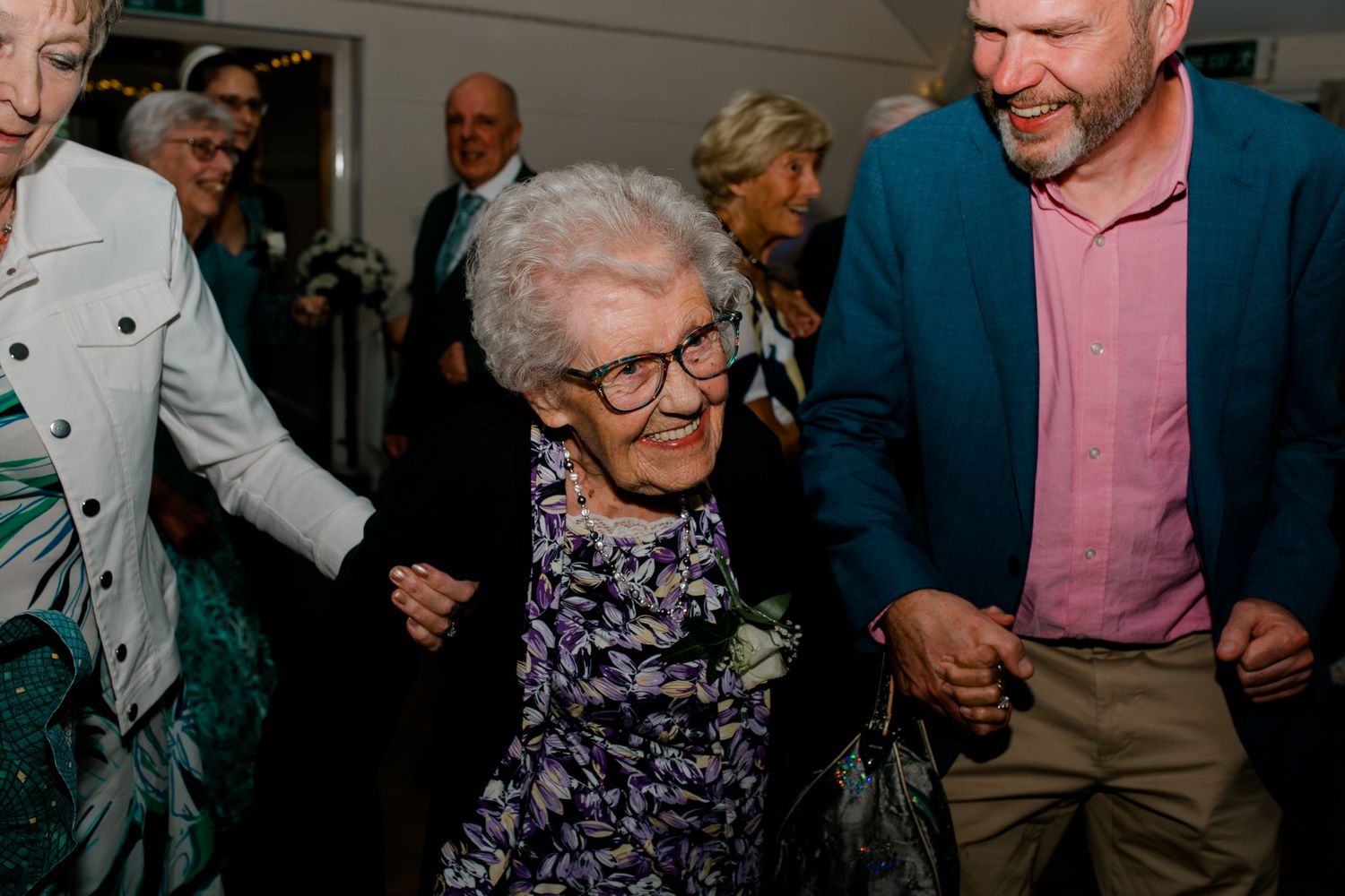 Wedding reception guests enjoying themselves during an evening celebration.