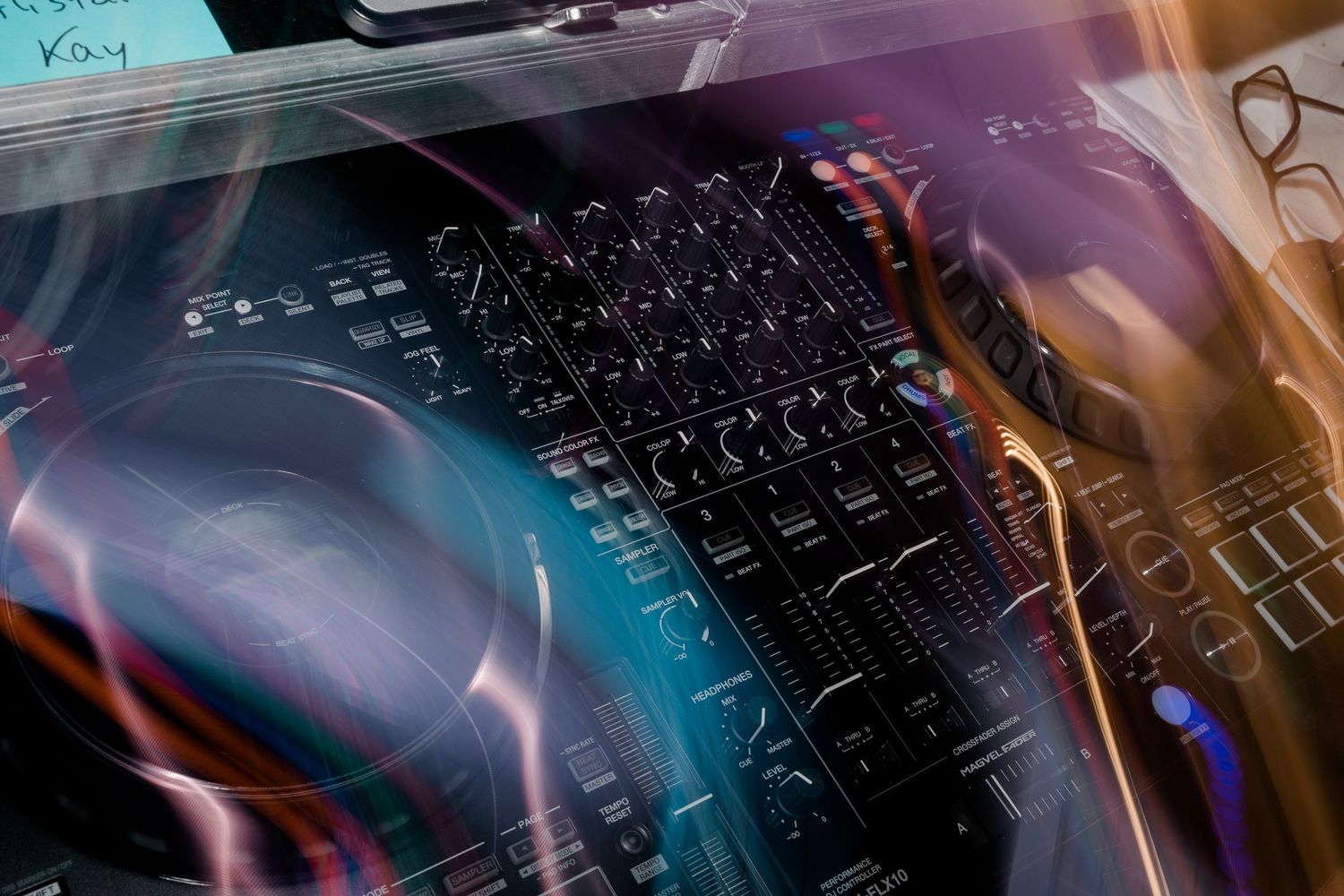 Abstract light trails and reflections on computer keyboard in blue and purple tones.