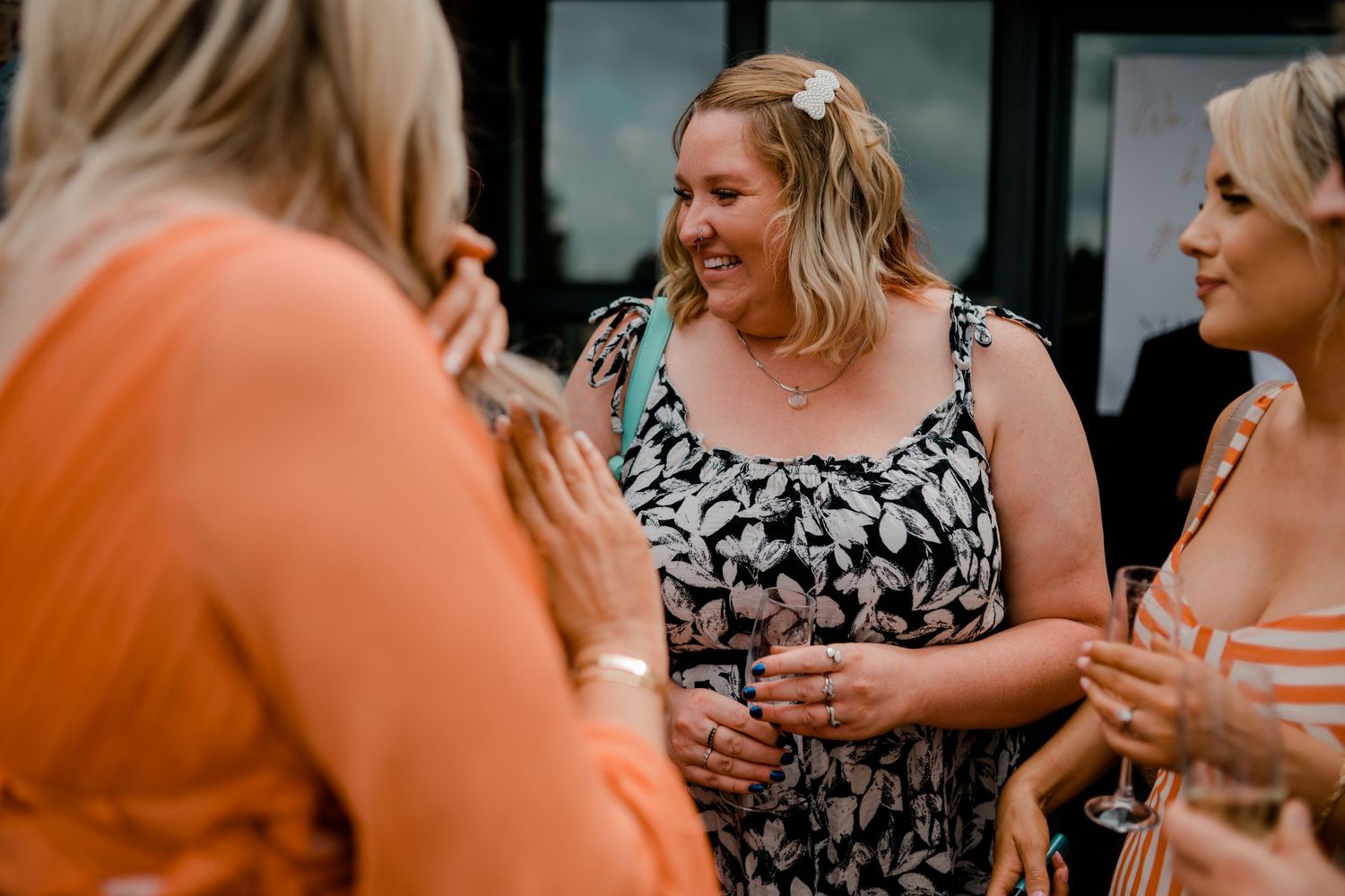 Wedding reception guests enjoying conversation and dancing at an evening celebration.