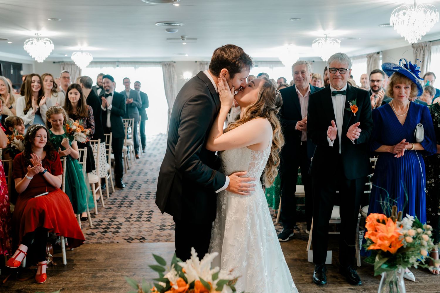 A romantic first dance moment at an elegant wedding reception with guests watching from the sides of the dance floor.