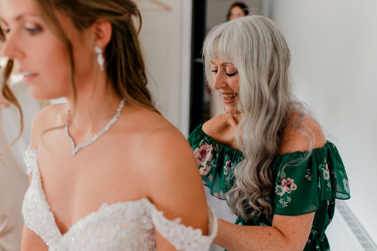 A group getting ready in formal attire with matching emerald green dresses and white gowns for a special celebration.