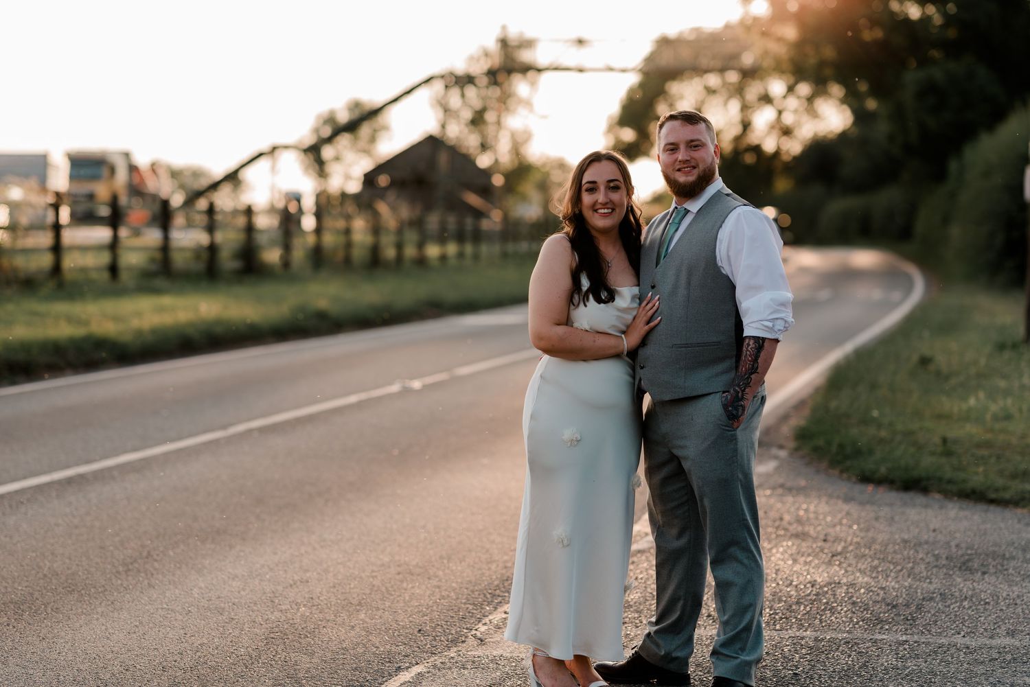 Couple walking together on path during golden hour sunset.