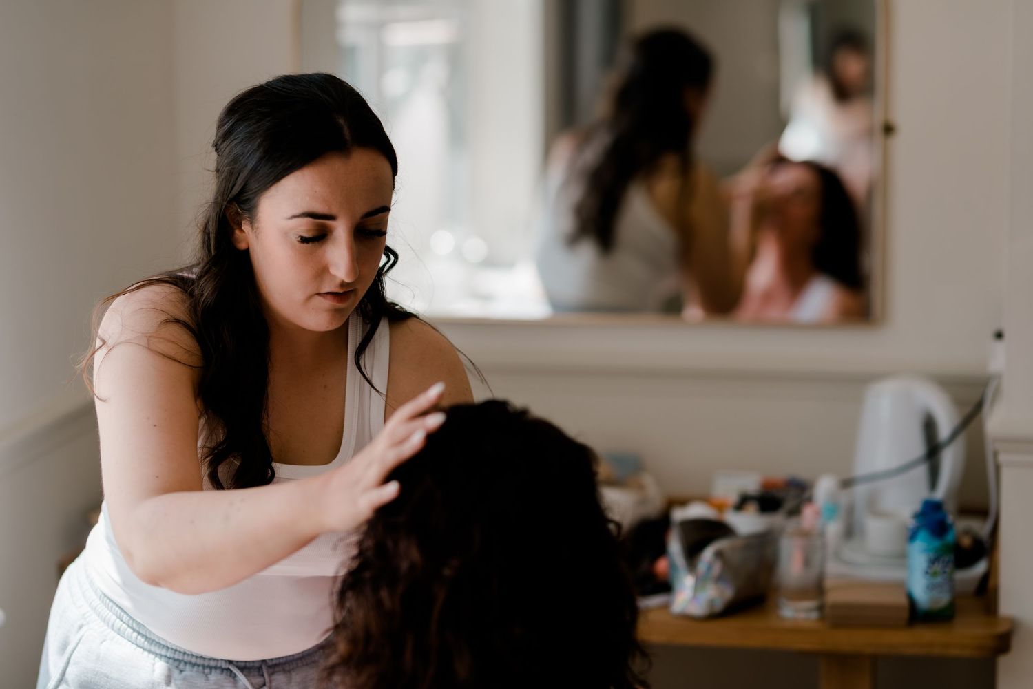 A wedding preparation scene in a brightly lit room with a styling session.