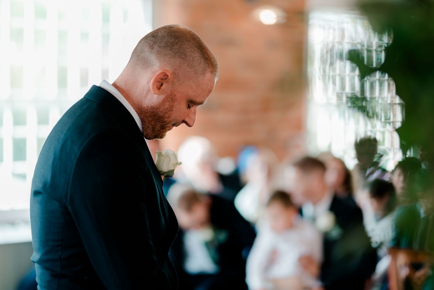 A tender moment captured during an indoor wedding ceremony.
