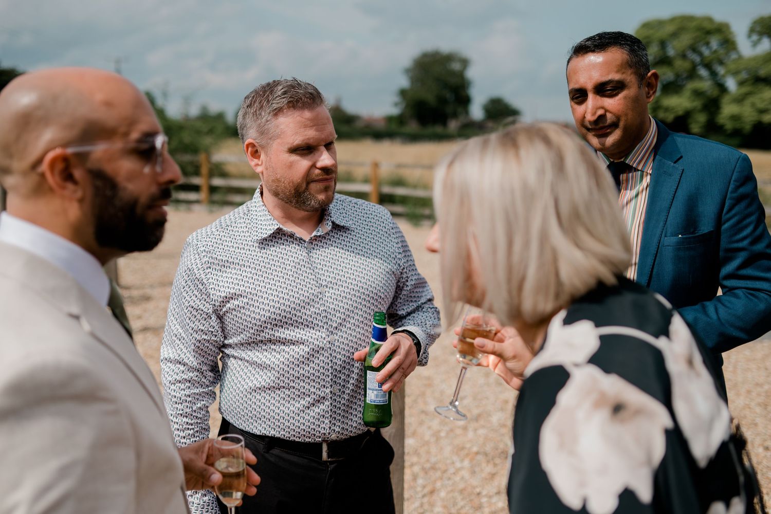 Wedding guests mingle and socialize during an outdoor summer reception.