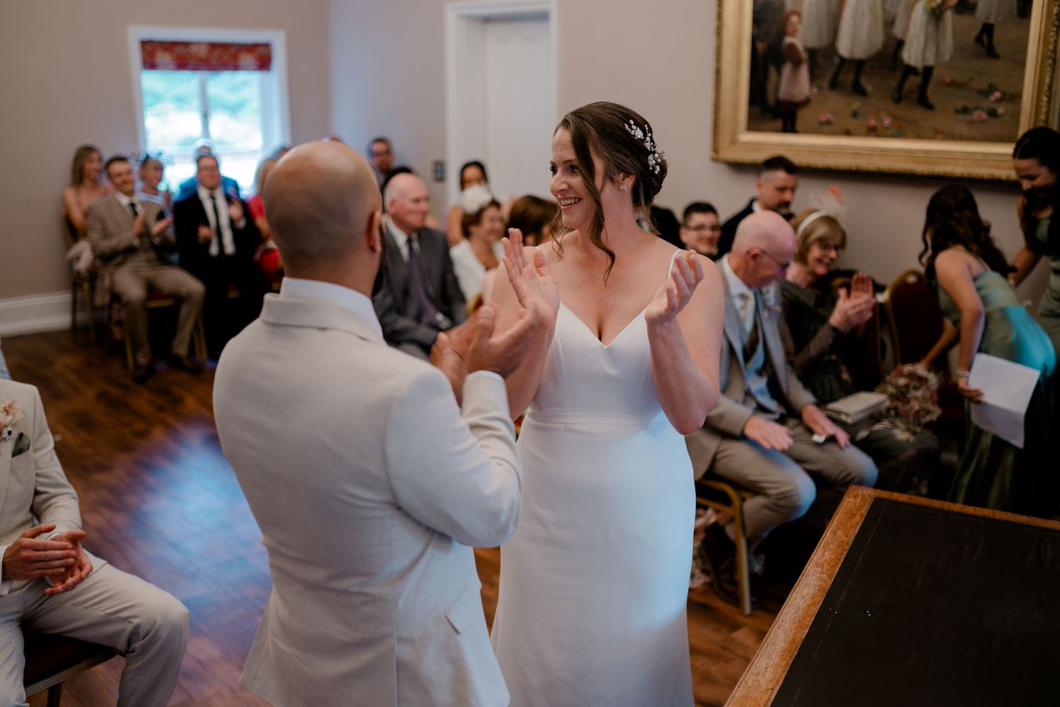 Wedding guests celebrate during an indoor reception with dancing and joyful moments.
