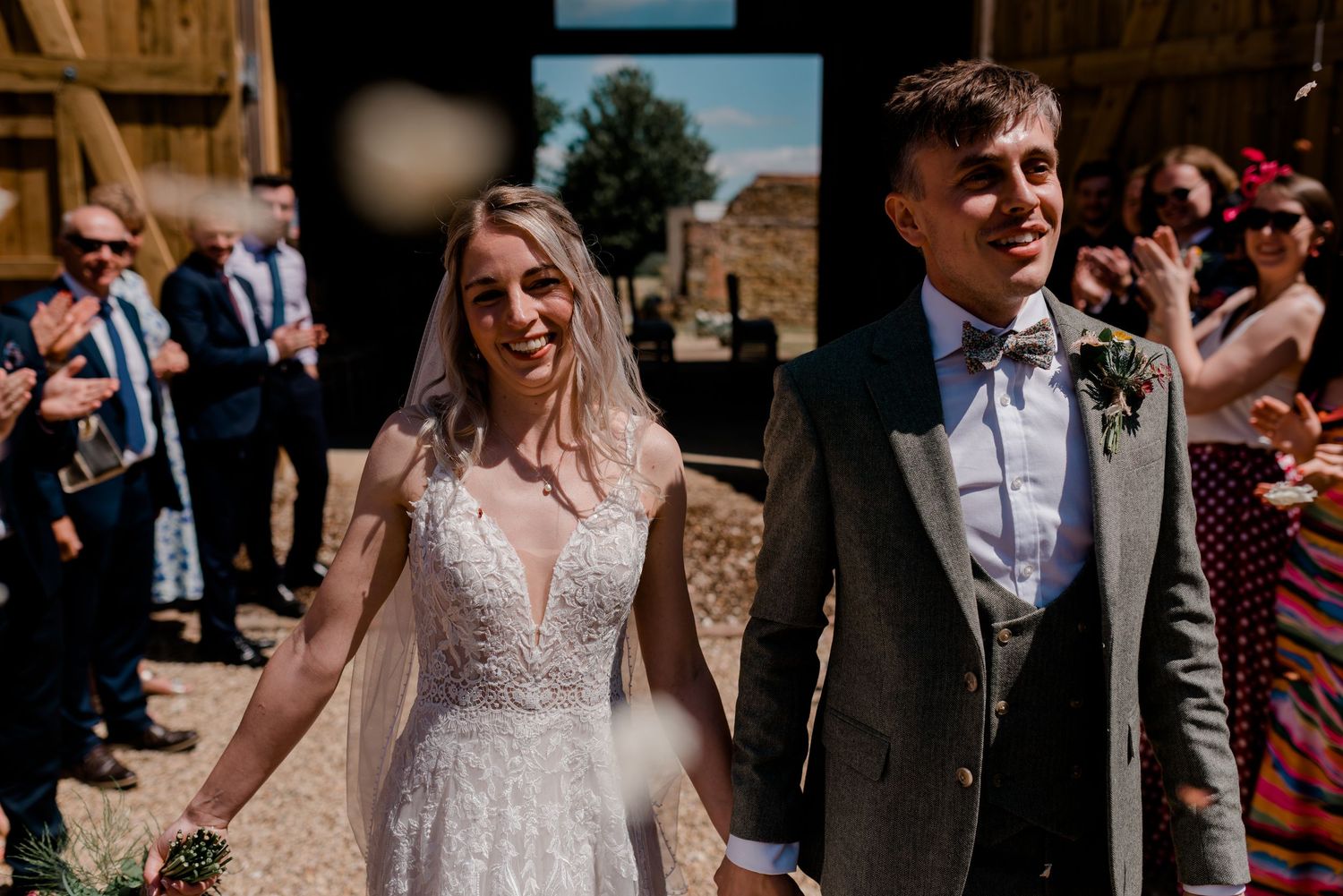 Couple shares intimate moments during a rustic barn wedding celebration.