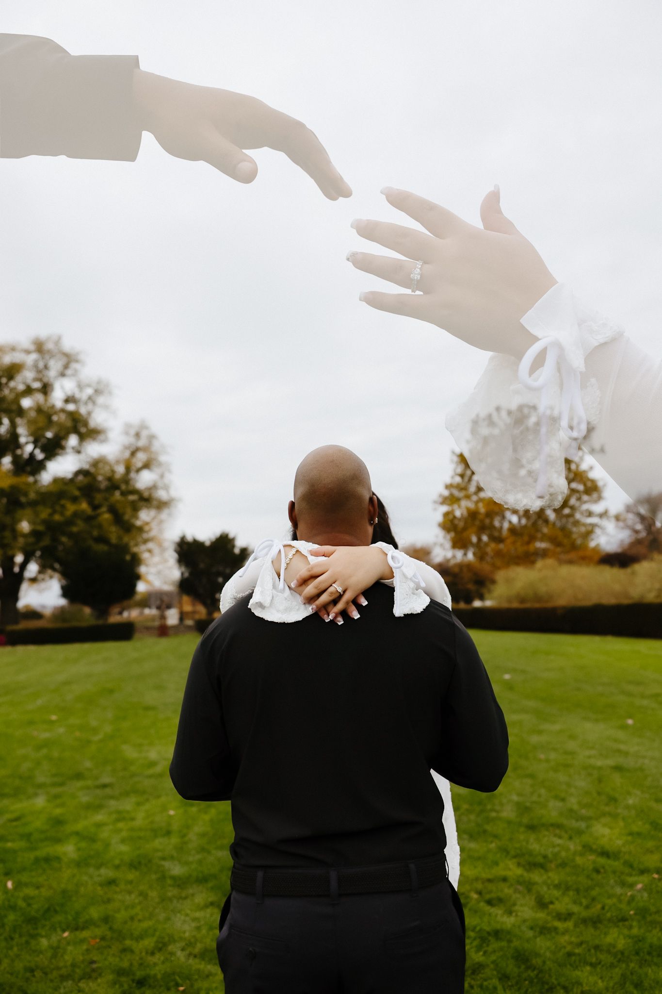 A romantic outdoor photo session captured against an overcast sky on grassy terrain.