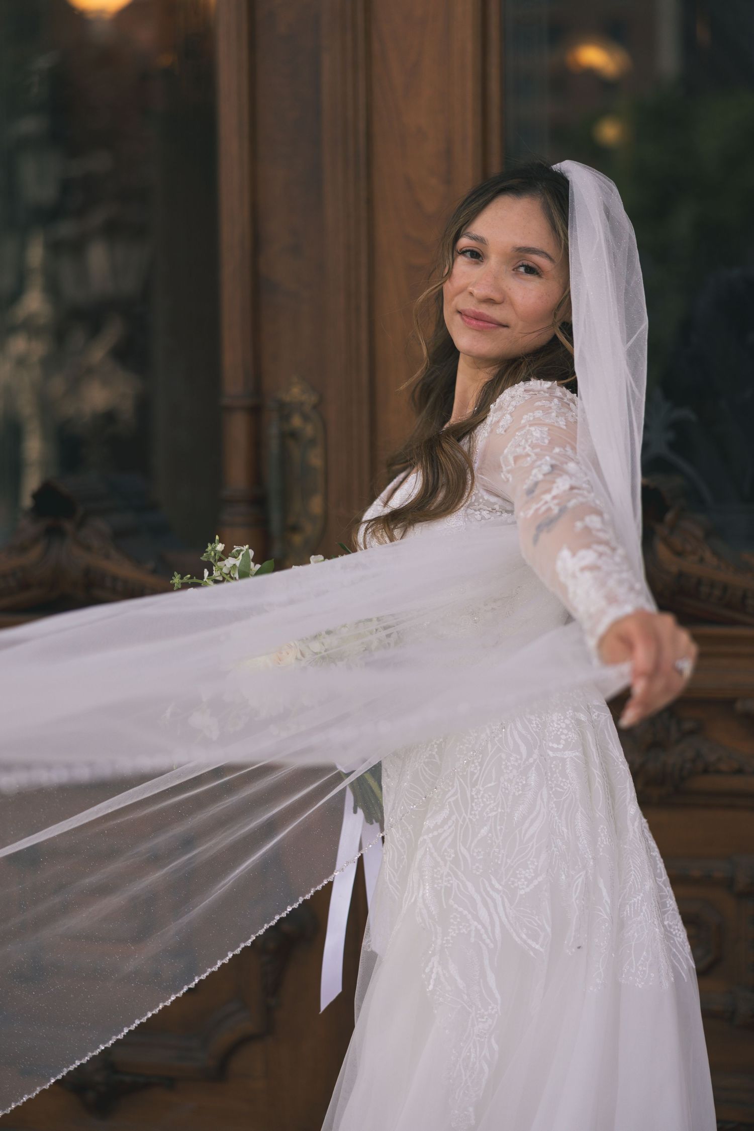 Bride in lace wedding dress twirls her veil in an artistic photo sequence.