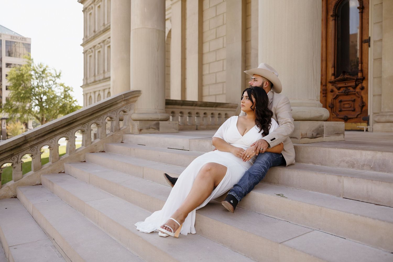 Series of artistic poses on elegant stone steps in formal white attire.