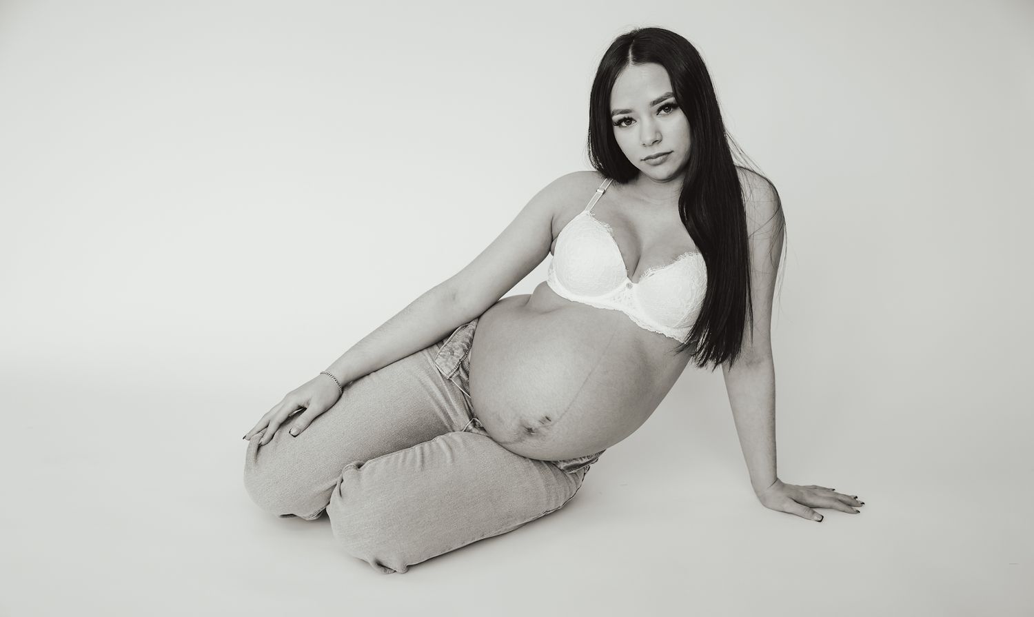 Artistic maternity portraits in minimalist style against white background.