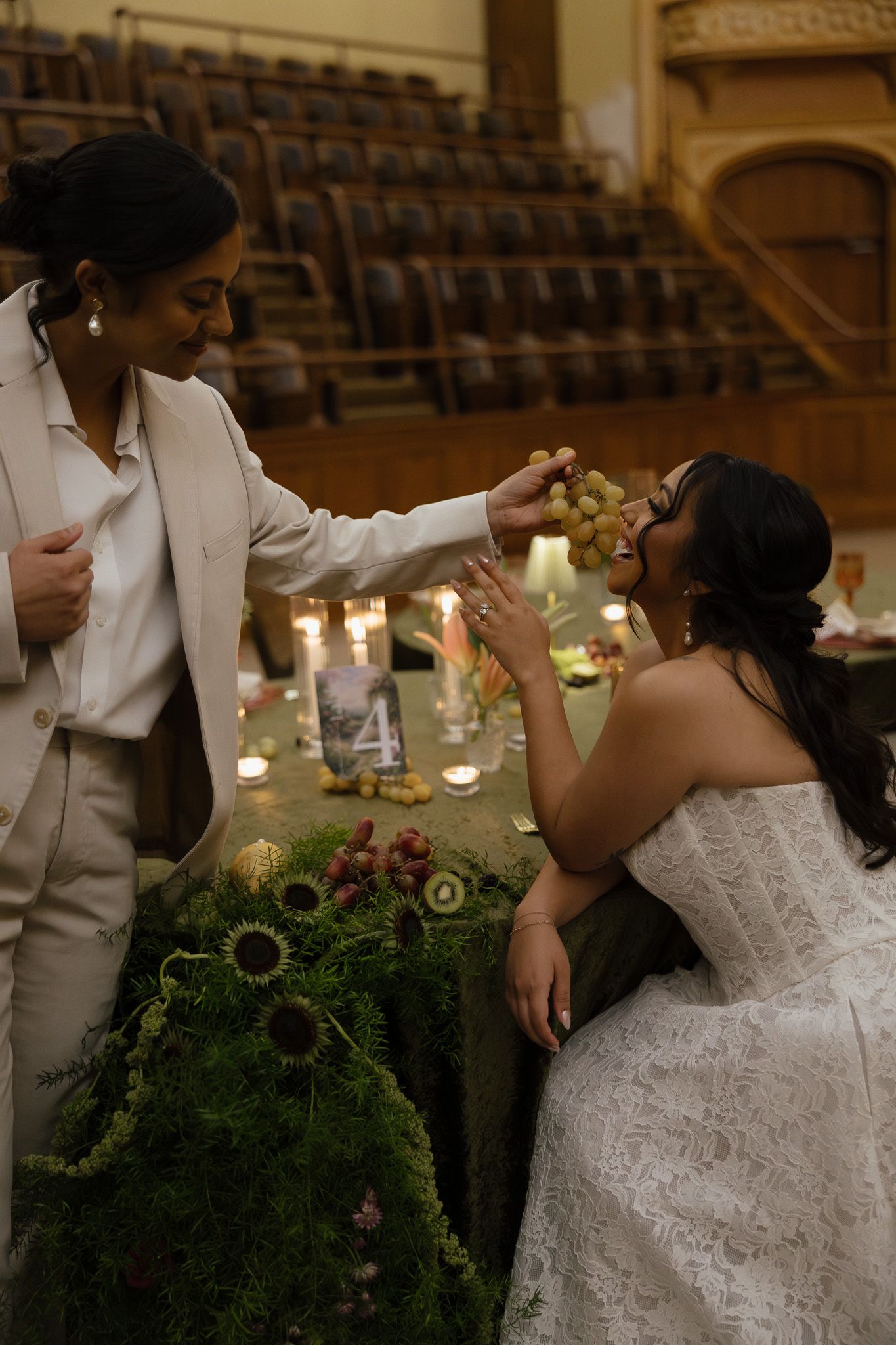 A romantic dance sequence at a wedding reception shows a couple in white attire twirling beneath ornate decor.