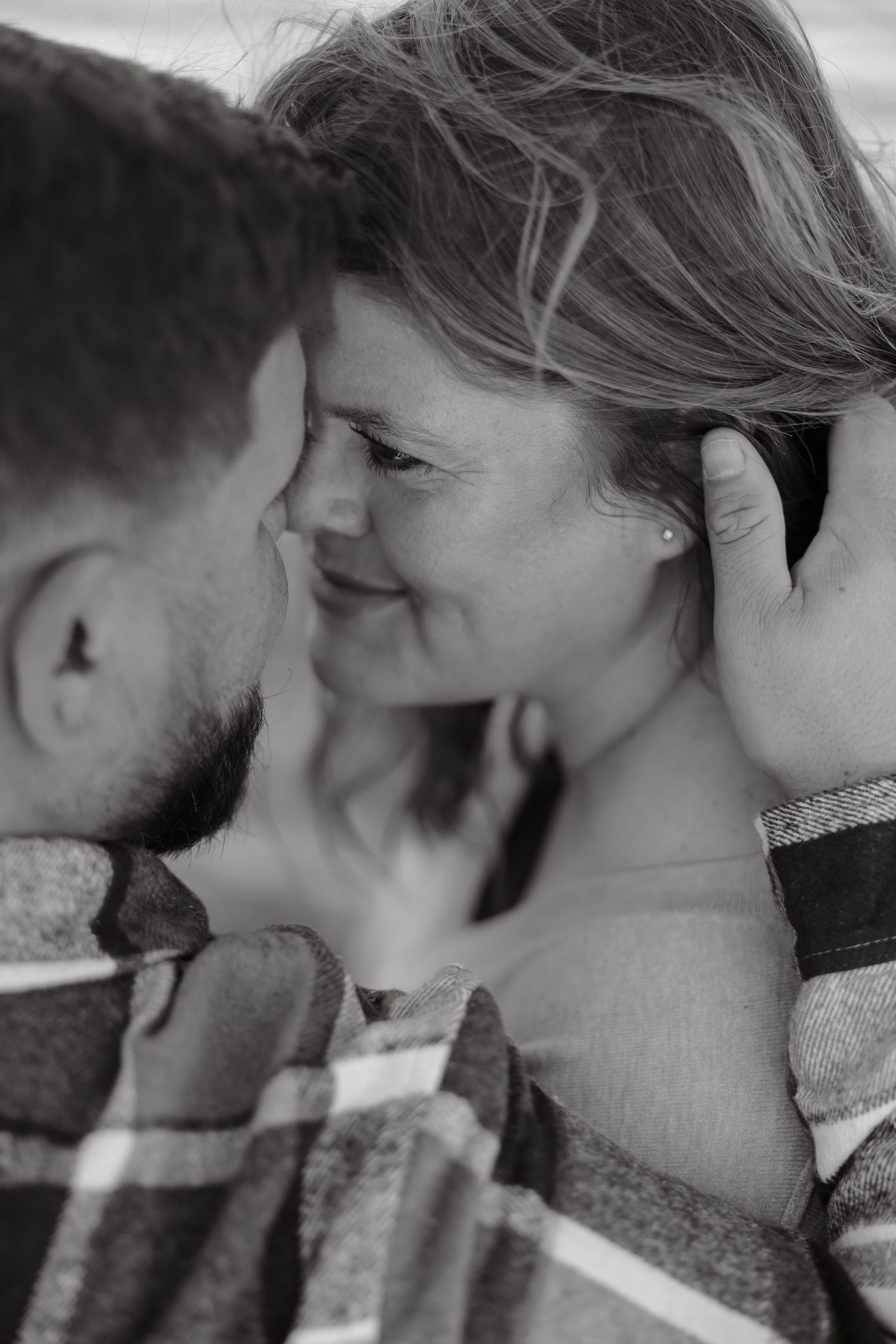 Black and white close-up sequence showing a romantic kiss between two people in profile view.