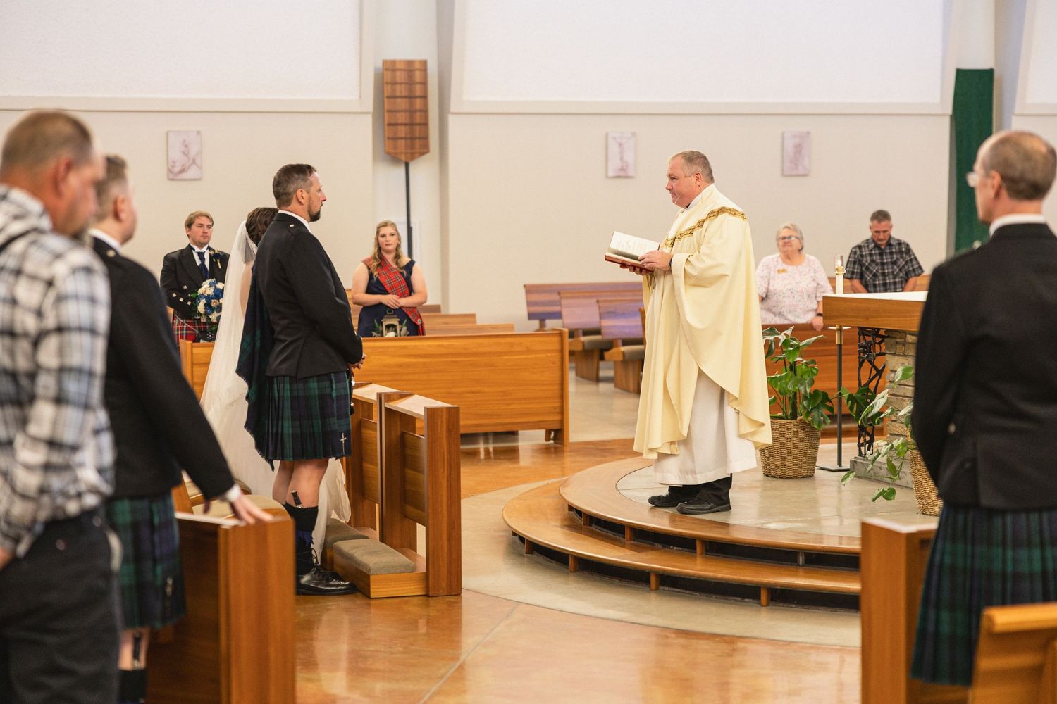 Religious ceremony in progress with traditional Scottish kilts and clergy in ceremonial robes.