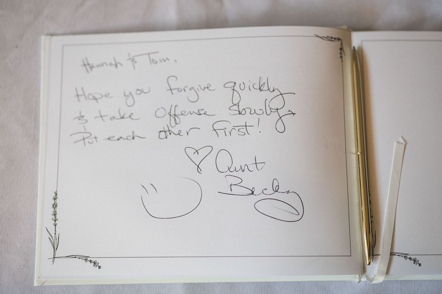 Handwritten guestbook note with pen on plain paper background.