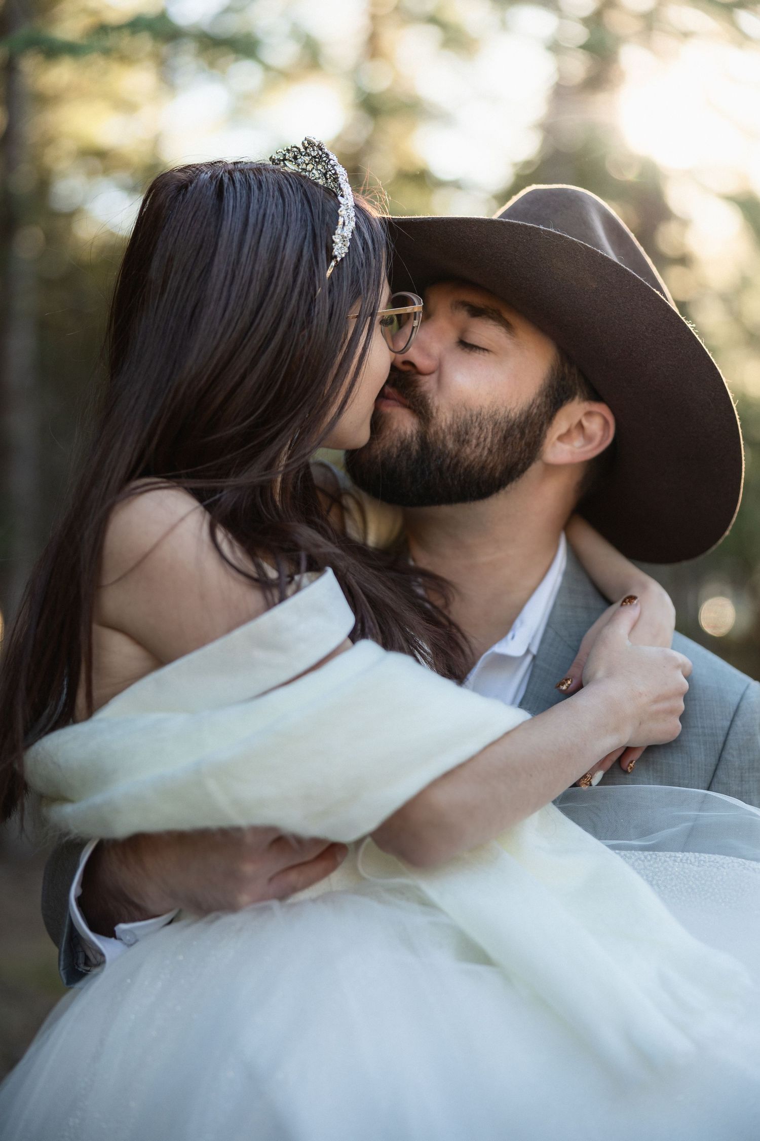 Intimate wedding portraits showing tender moments between newlyweds in a forest setting.