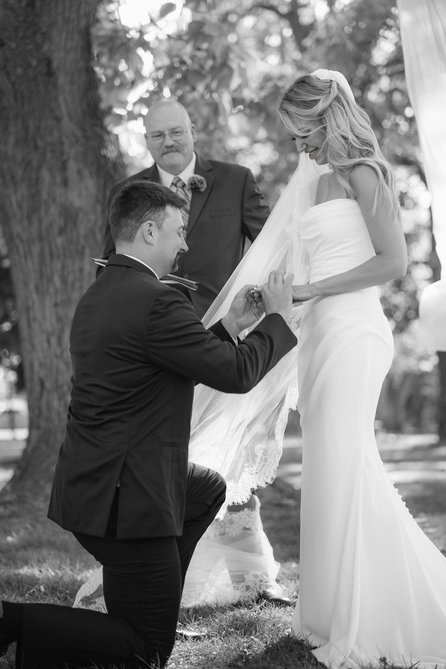 Black and white images showing playful moments between a couple in formal attire.