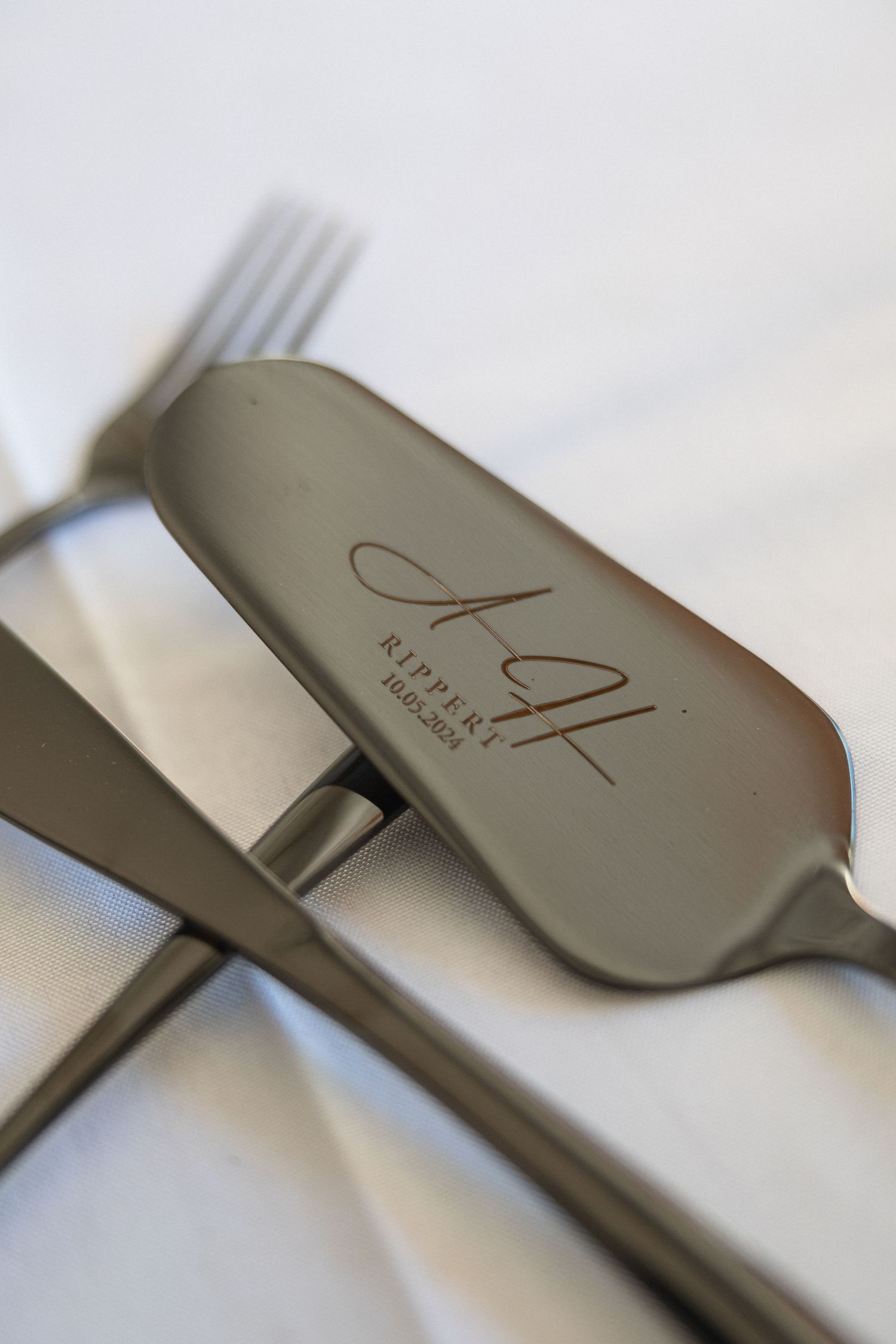 Closeup of an engraved silver flatware piece from AZ Alpikist restaurant.