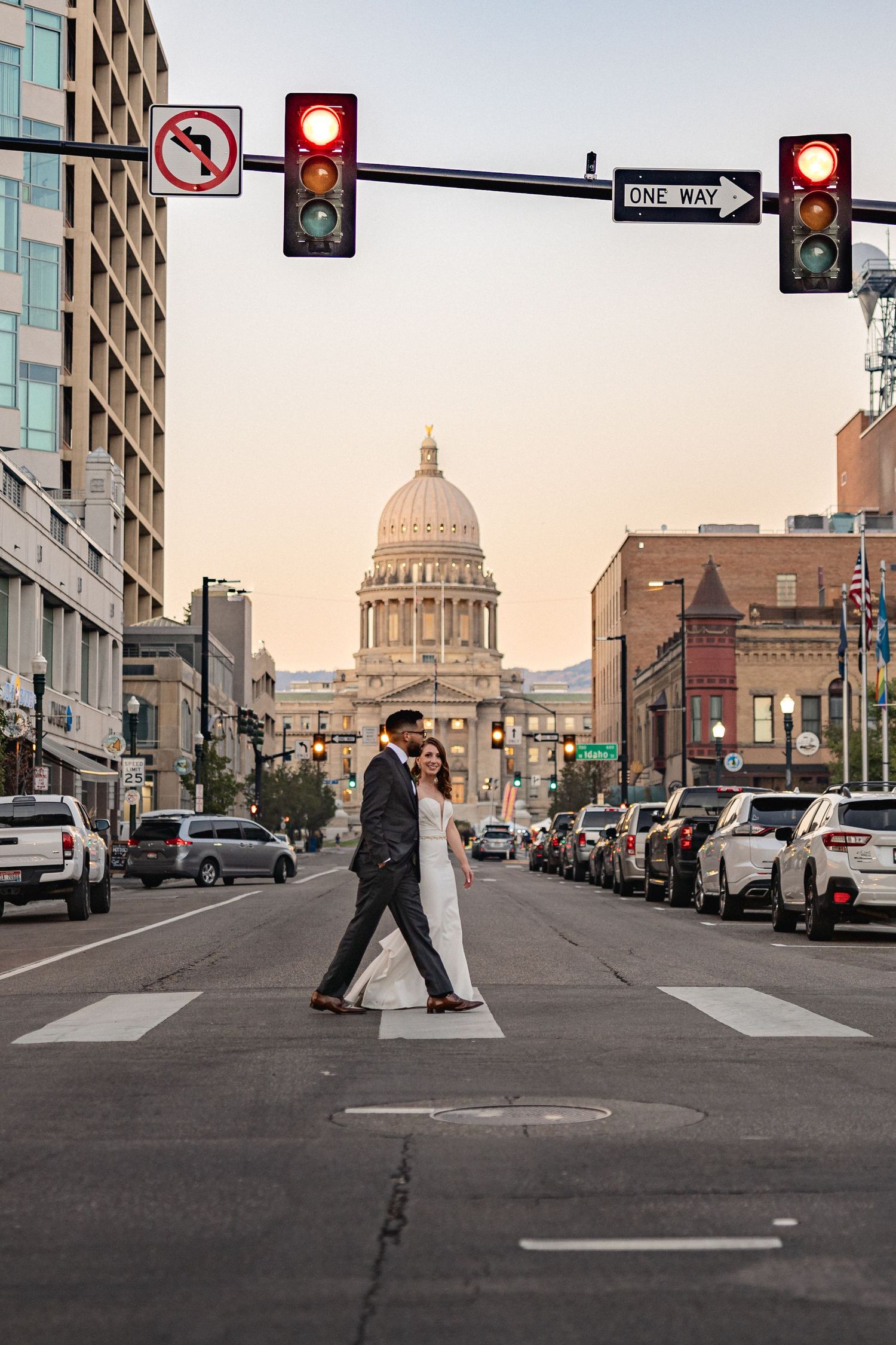Outdoor city street view showing the Idaho State Capitol building in the background at sunset.