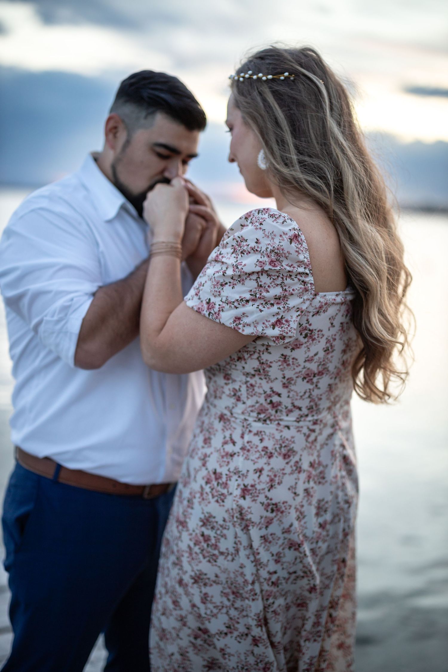 Romantic sunset moment shared by water's edge.