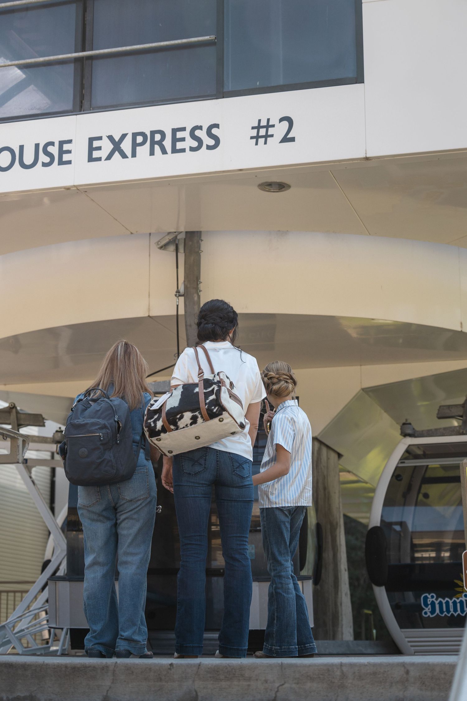 People standing in line outside a building with Express signage visible.