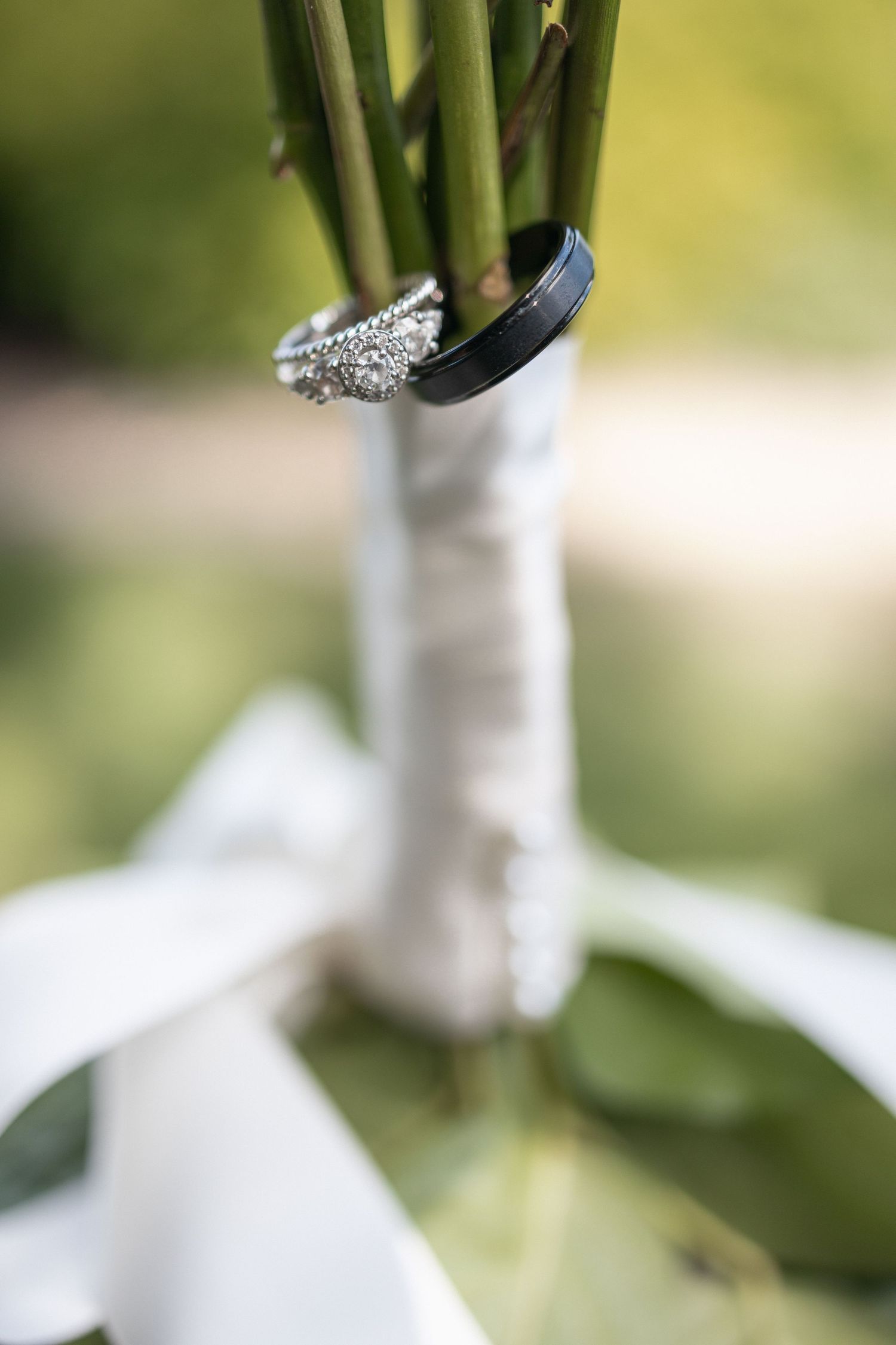 Close-up of a sparkling diamond engagement ring with intricate details against a soft blurred background.