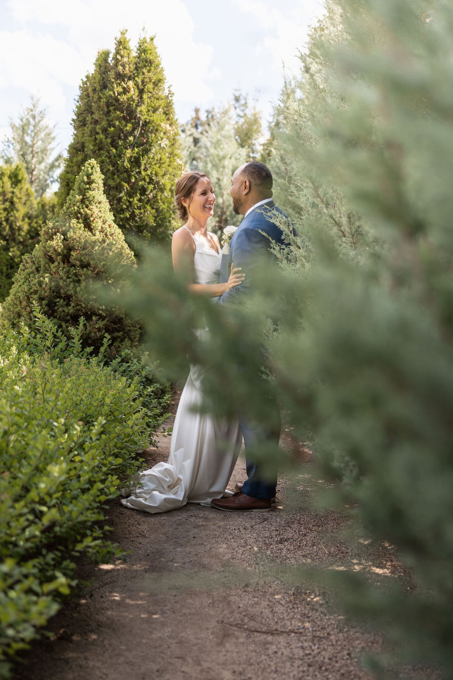 A tender moment captured between newlyweds in a serene garden setting.