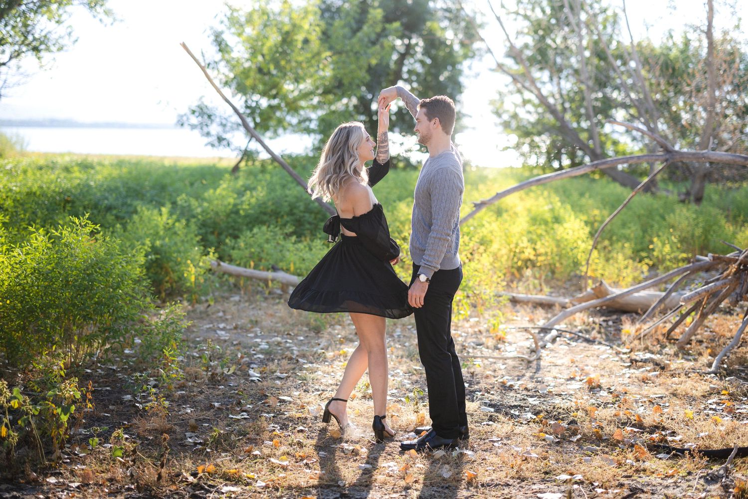 Dancing couple on nature trail during sunset.