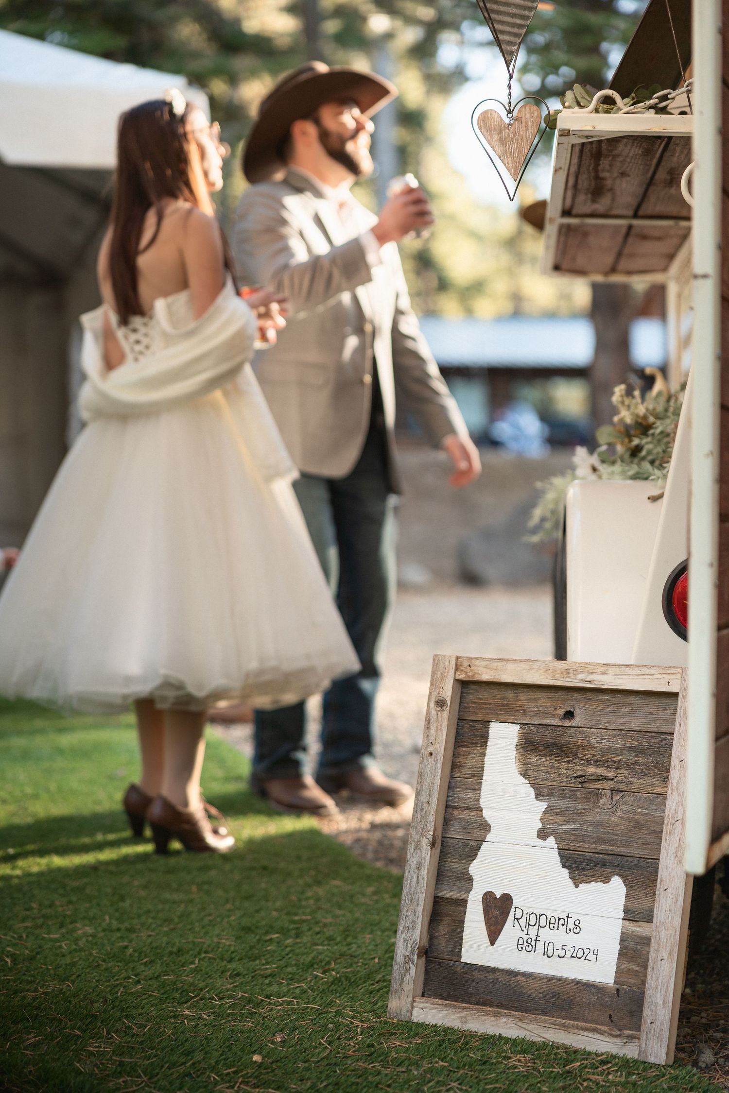 Rustic wedding decor featuring wooden Idaho state sign with heart detail.