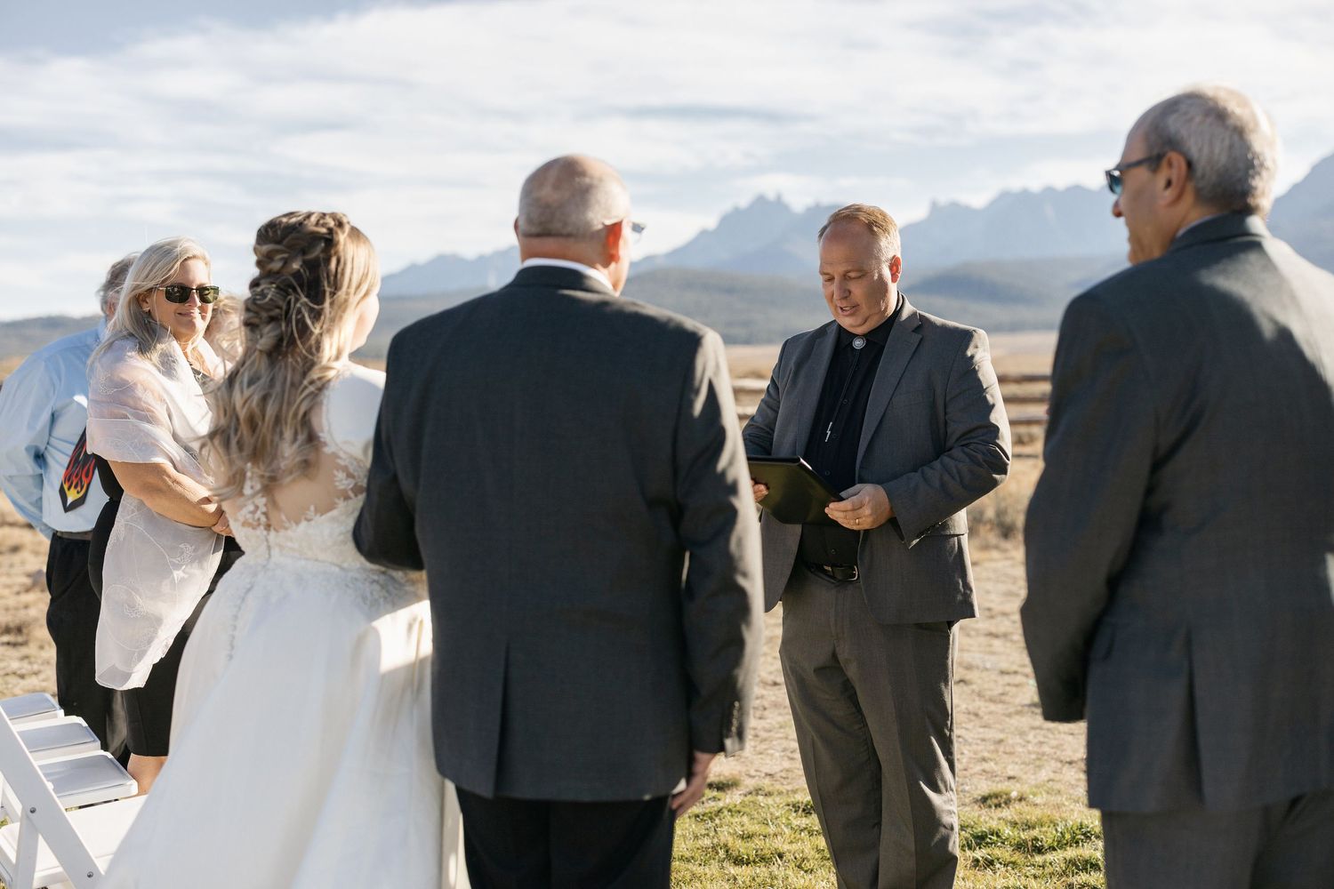 Wedding ceremony gathering with mountain vista in background.